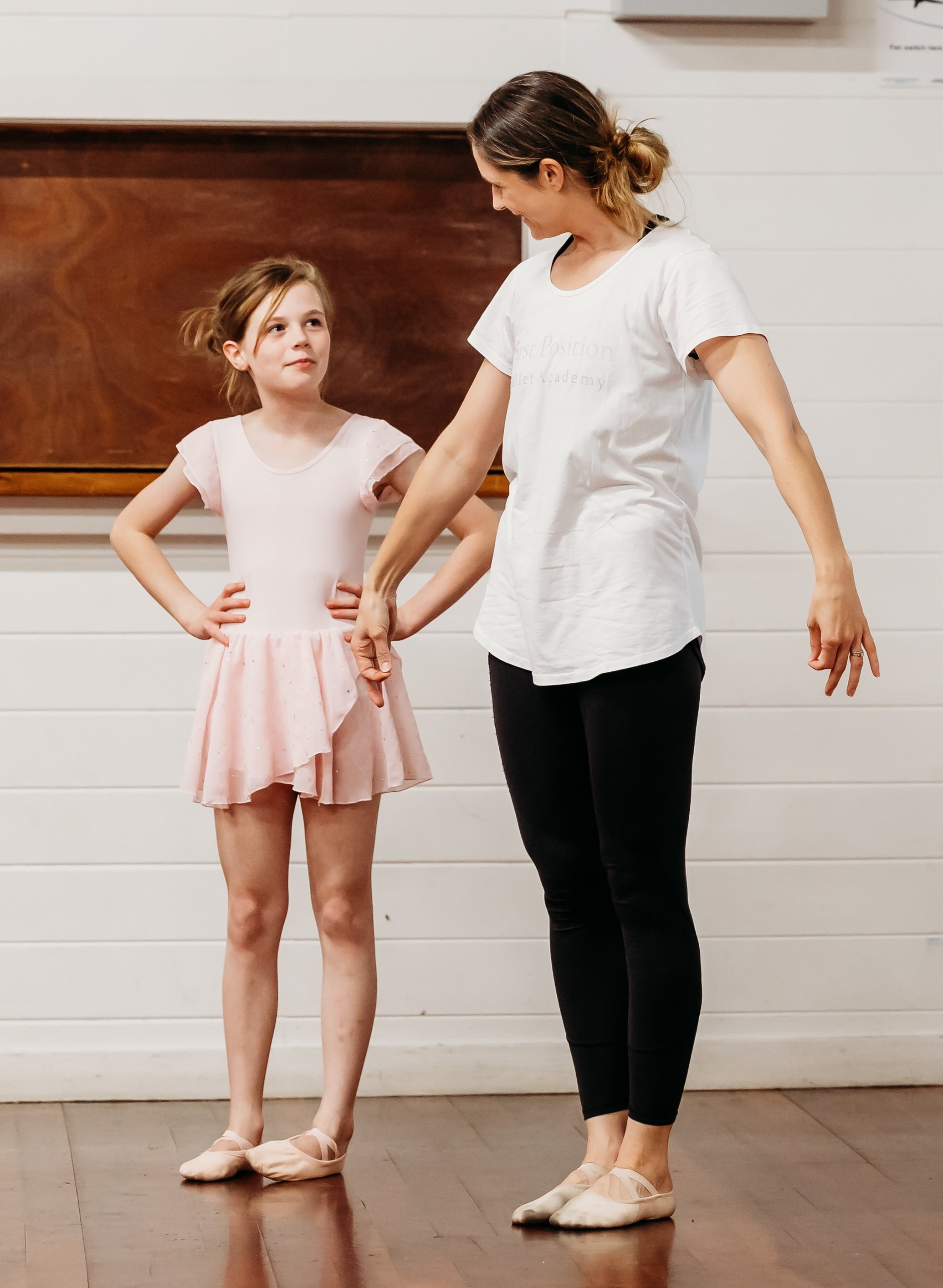 Young dancer and ballet teacher looking at each ready to dance