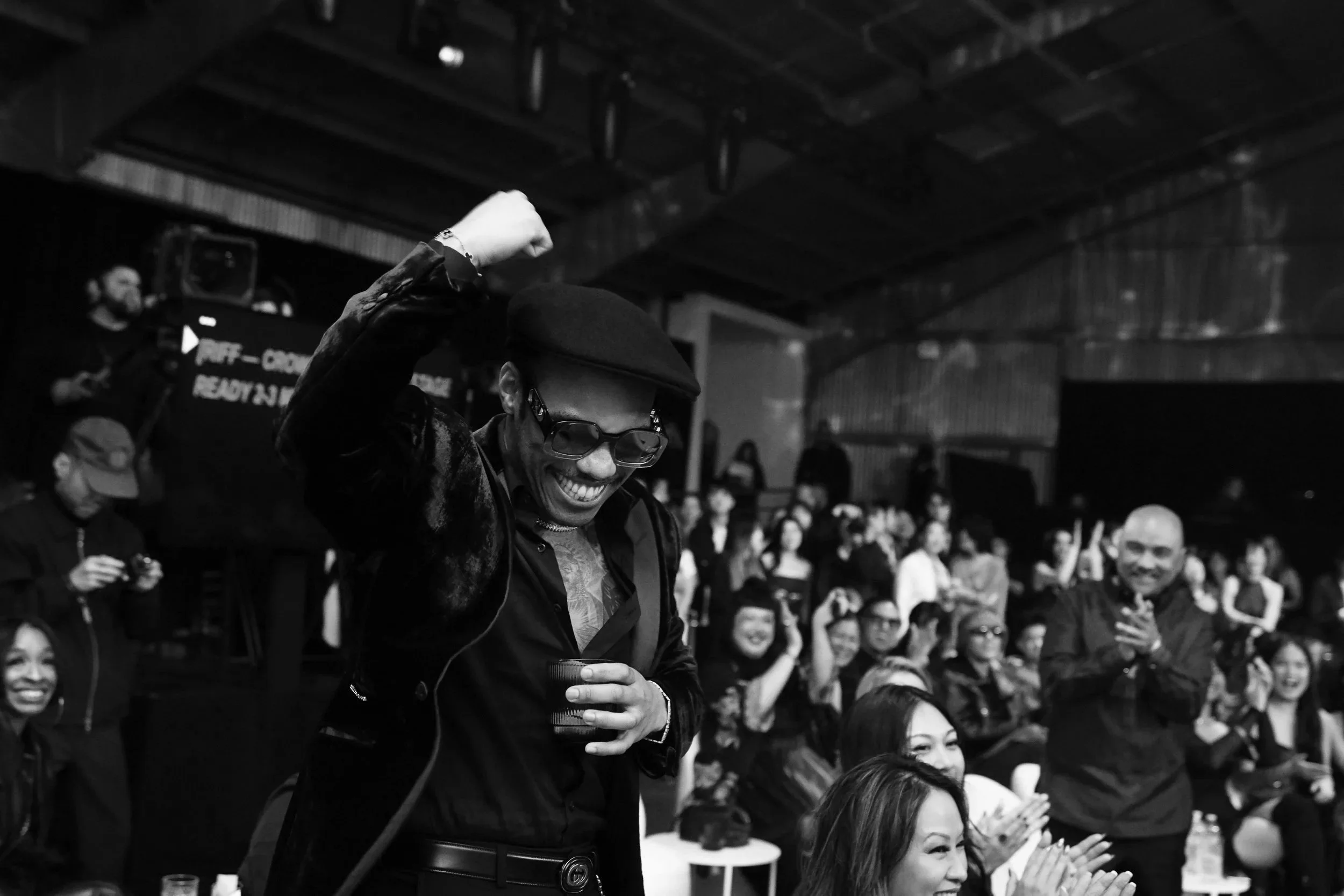 Anderson .Paak at 88rising's lunar new year moonrise gala with a seated audience clapping and smiling.