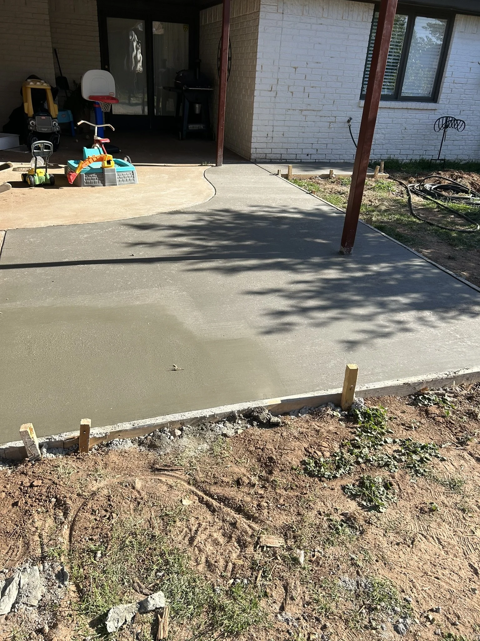 Finished residential concrete patio pad designed for outdoor living.