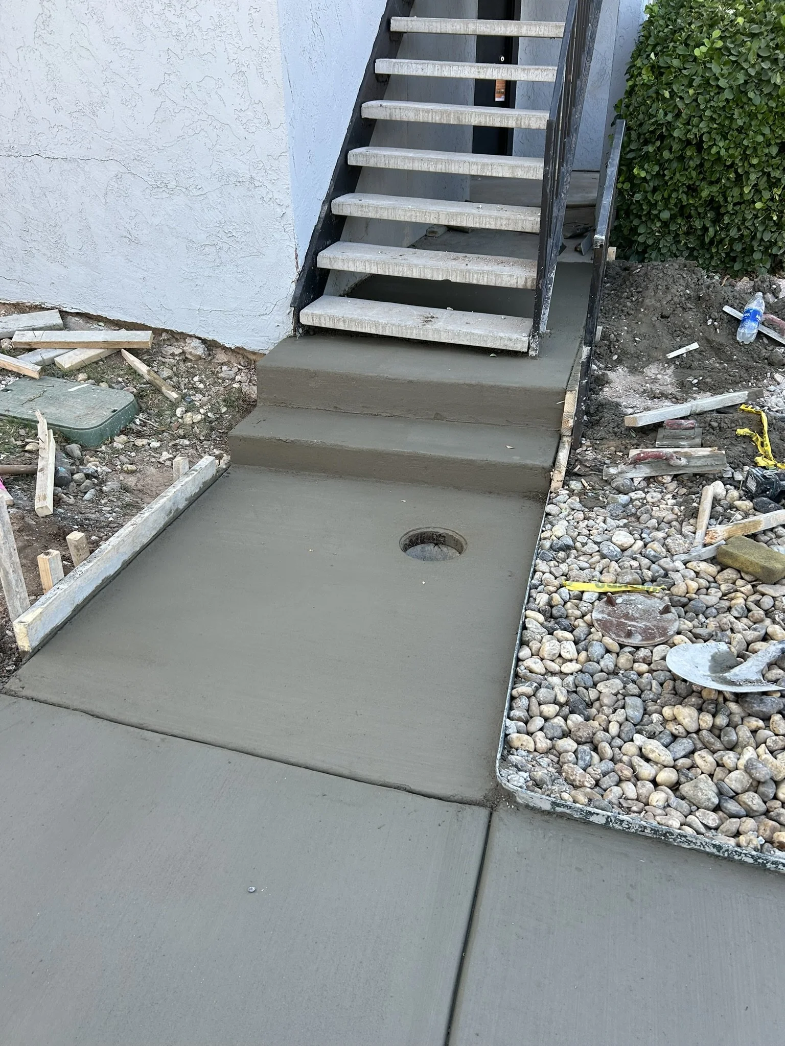 Finished brushed concrete steps and entryway construction.