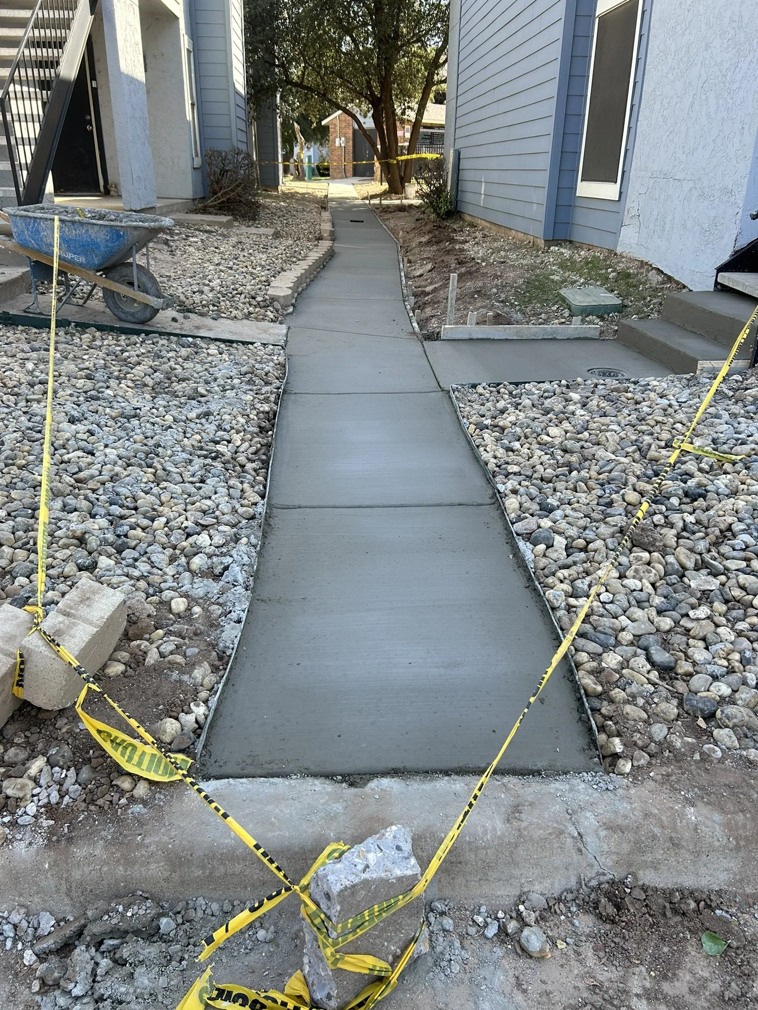 Custom concrete walkway connecting front and backyard areas