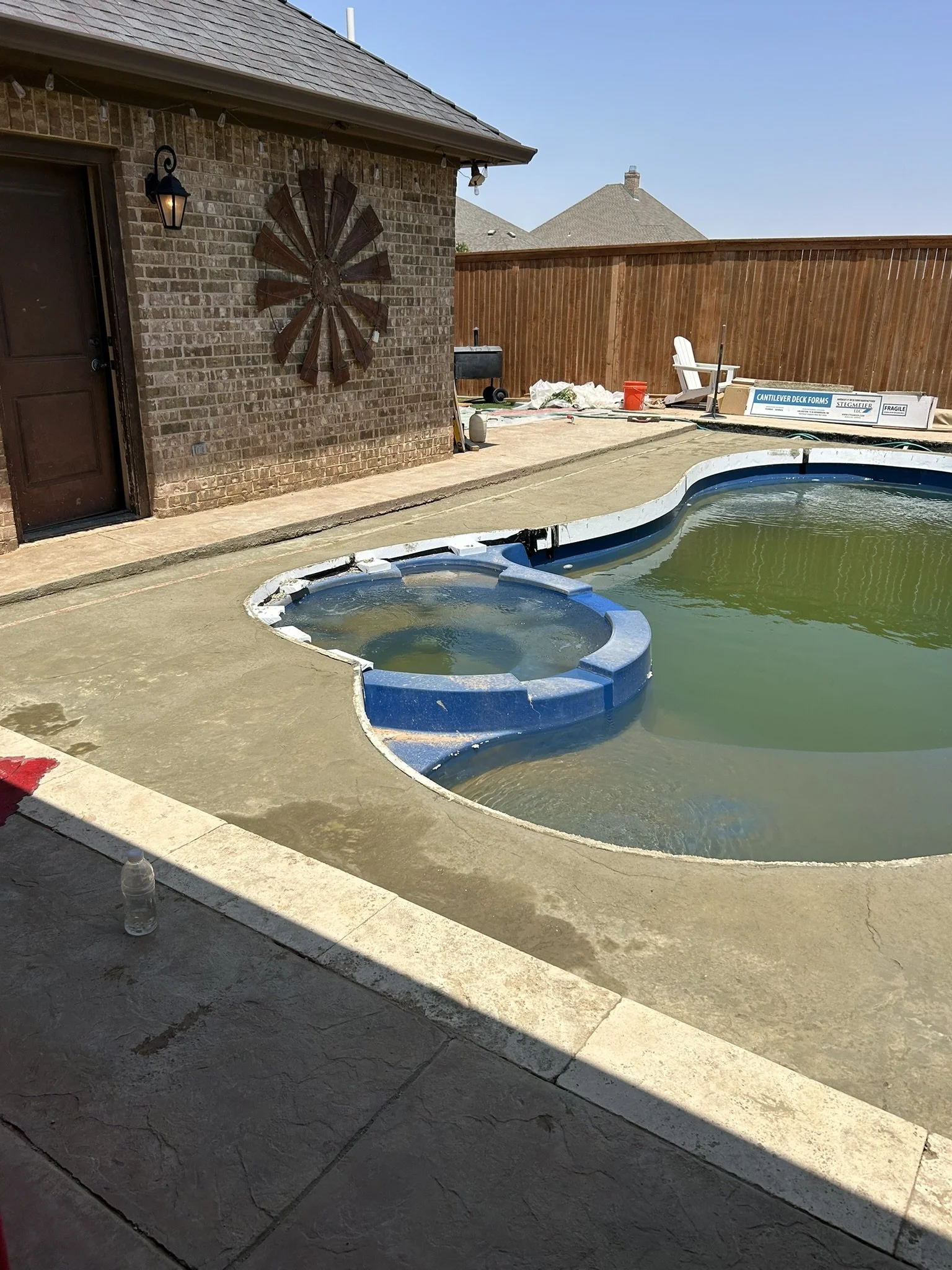 Completed inground pool backfill and concrete patio extension.