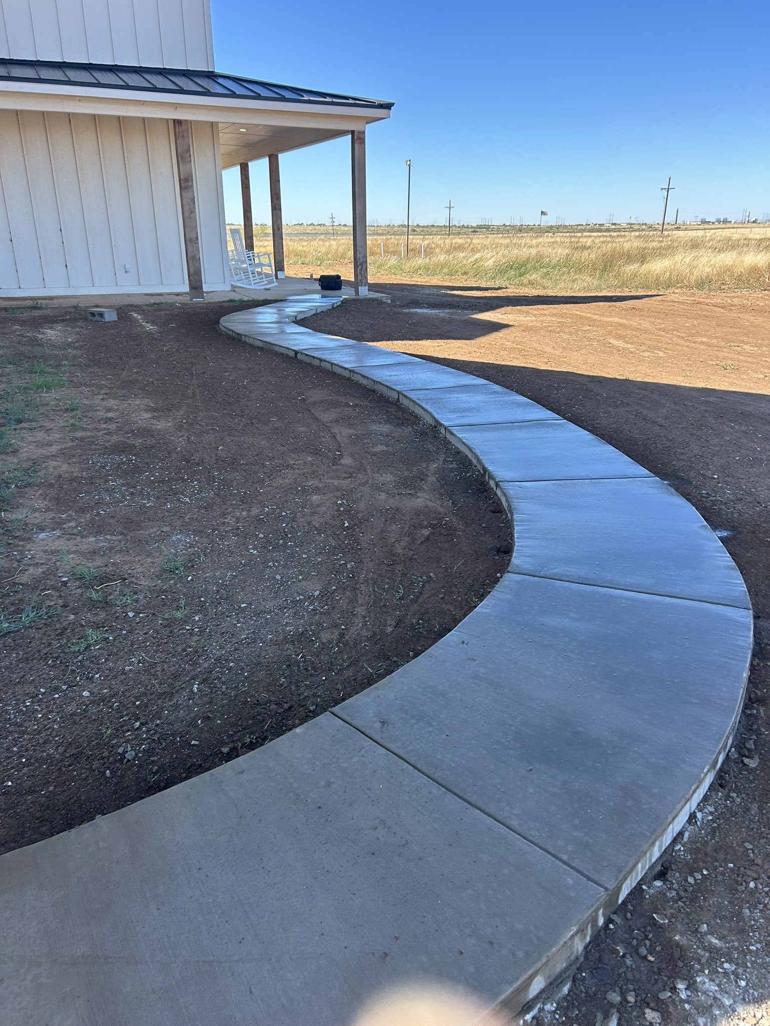 Curved concrete sidewalk in West Texas