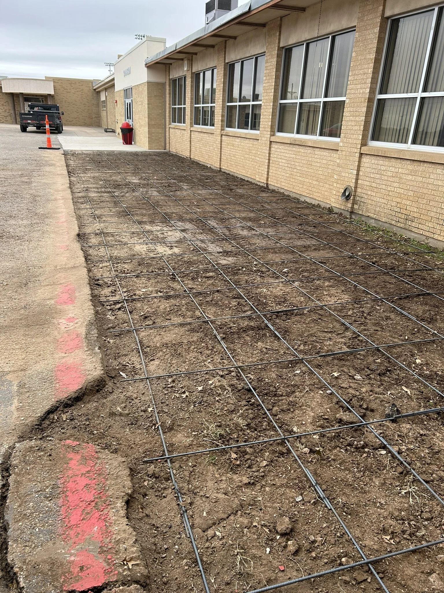 Rebar installation and prep work for concrete extension for local high school