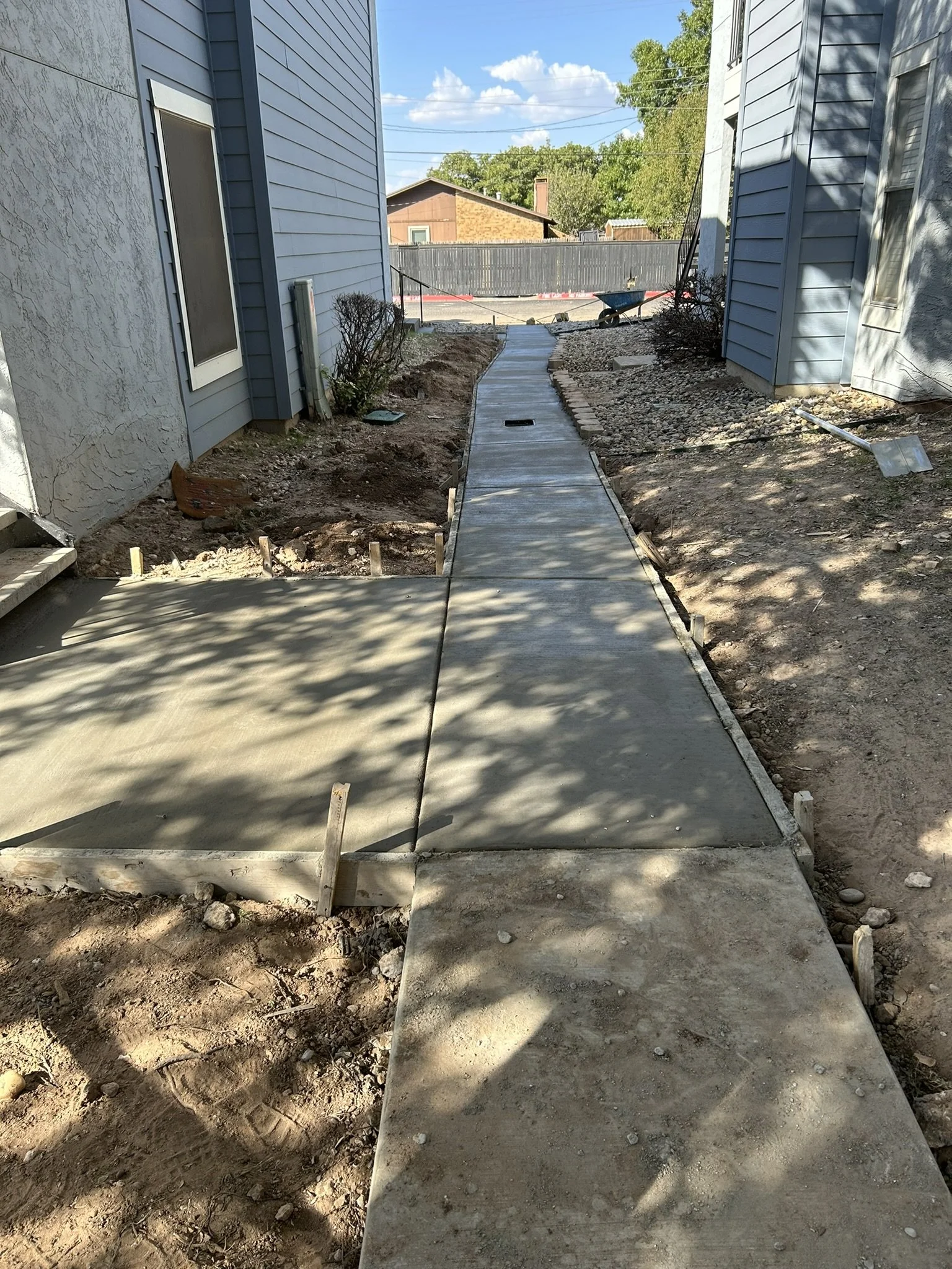 Long concrete pathway poured and finished for residential property.