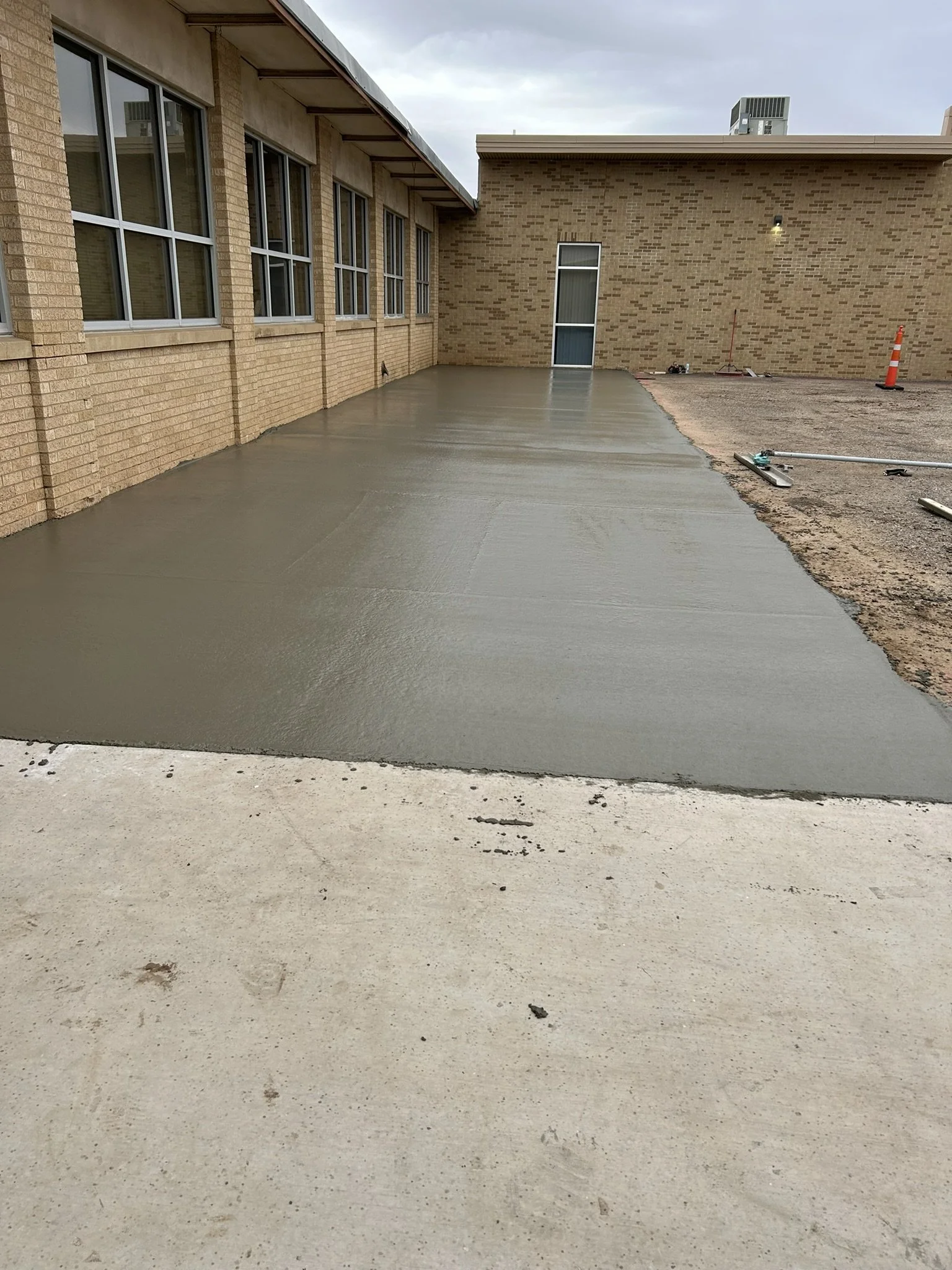 High-quality concrete driveway extension for additional vehicle parking.