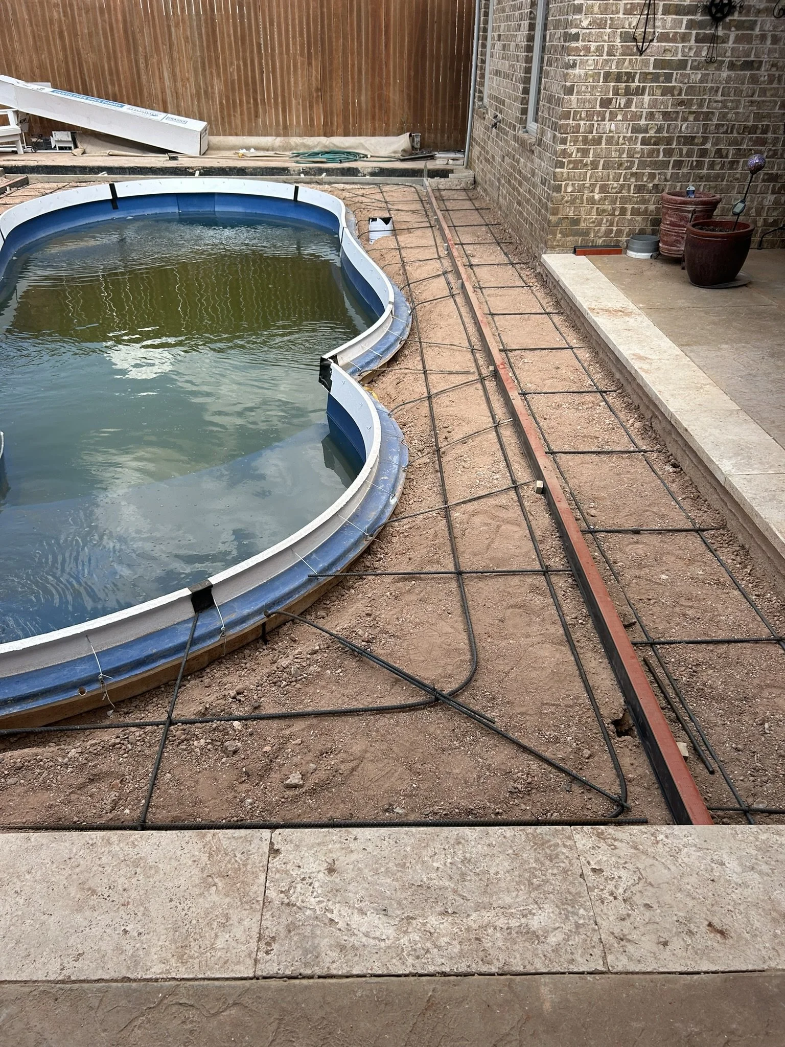 Installing steel rebar reinforcement grid for a durable concrete pool deck