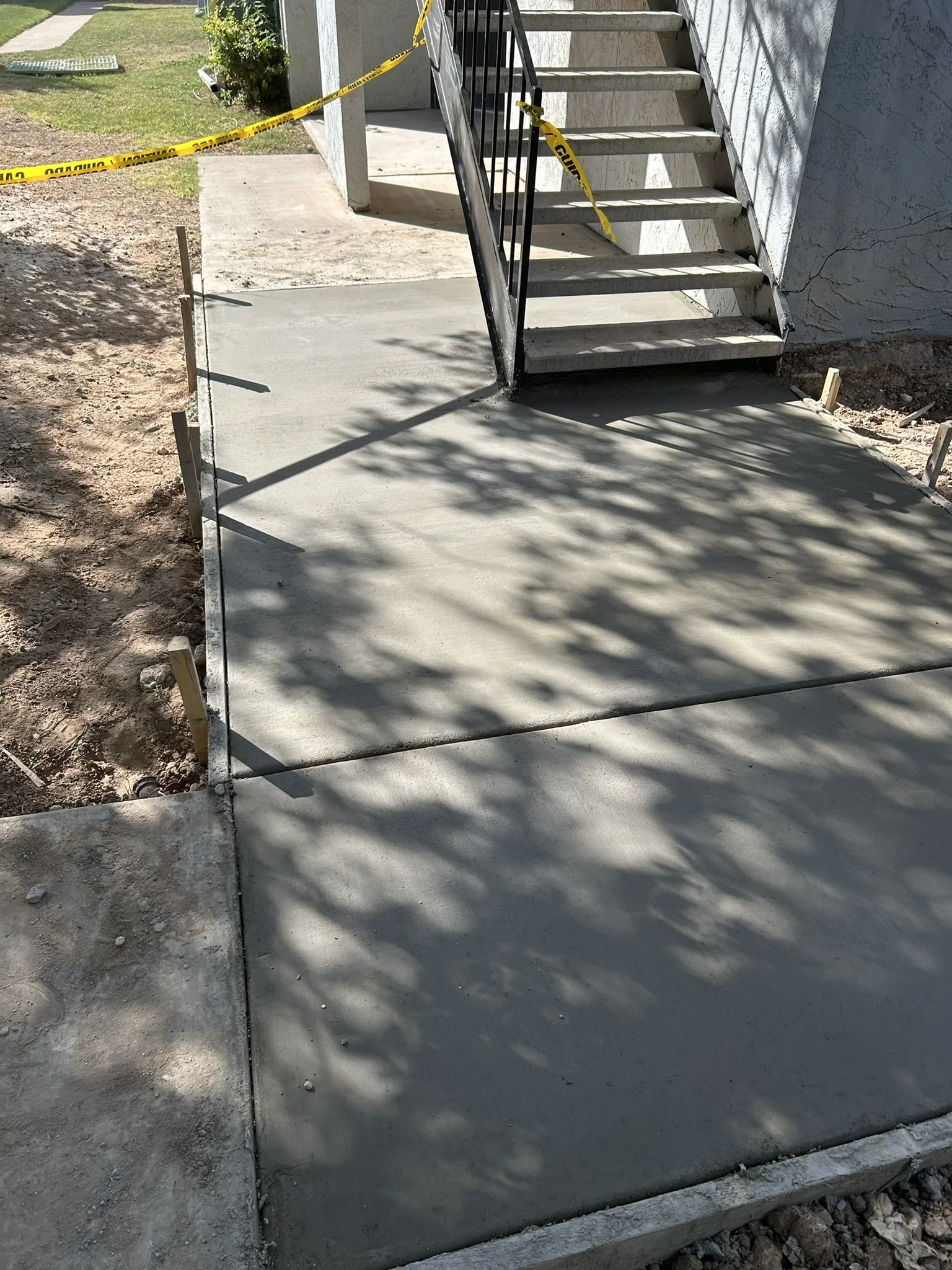 Clean, newly poured concrete sidewalk section in Lubbock, Texas.