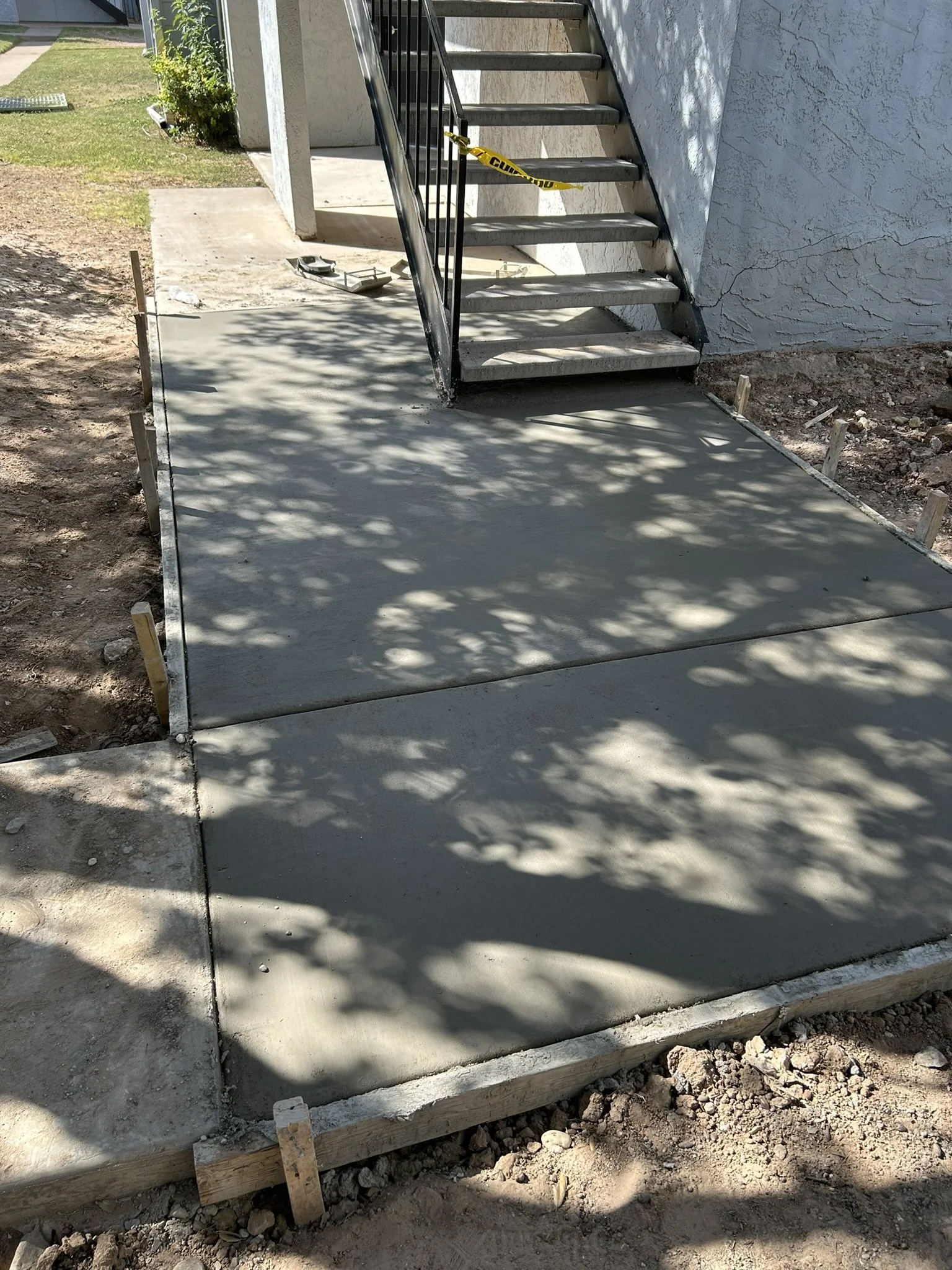 Durable brushed concrete sidewalk path for local home access.