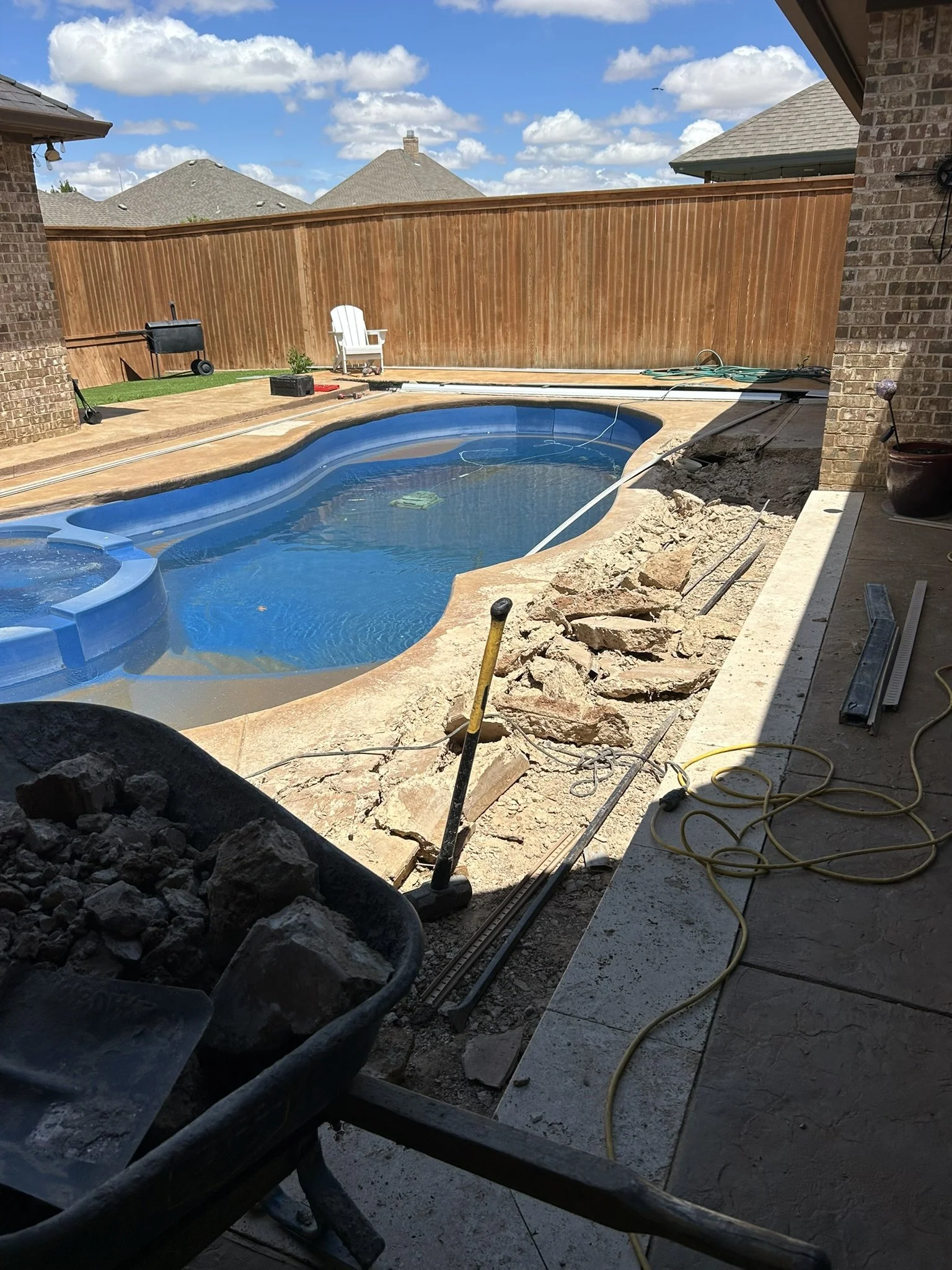 Swimming pool demolition and backyard excavation prep work in Lubbock, Texas.