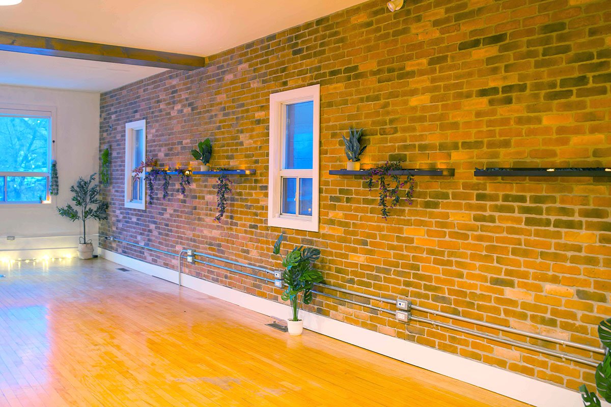 Wellness practice studio at Avir Wellness with exposed brick walls and a warm, inviting atmosphere for independent practitioners