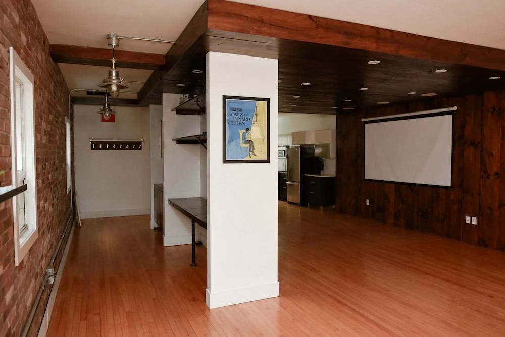 Engle thought it warm the studio with Leonard Cohen poster.