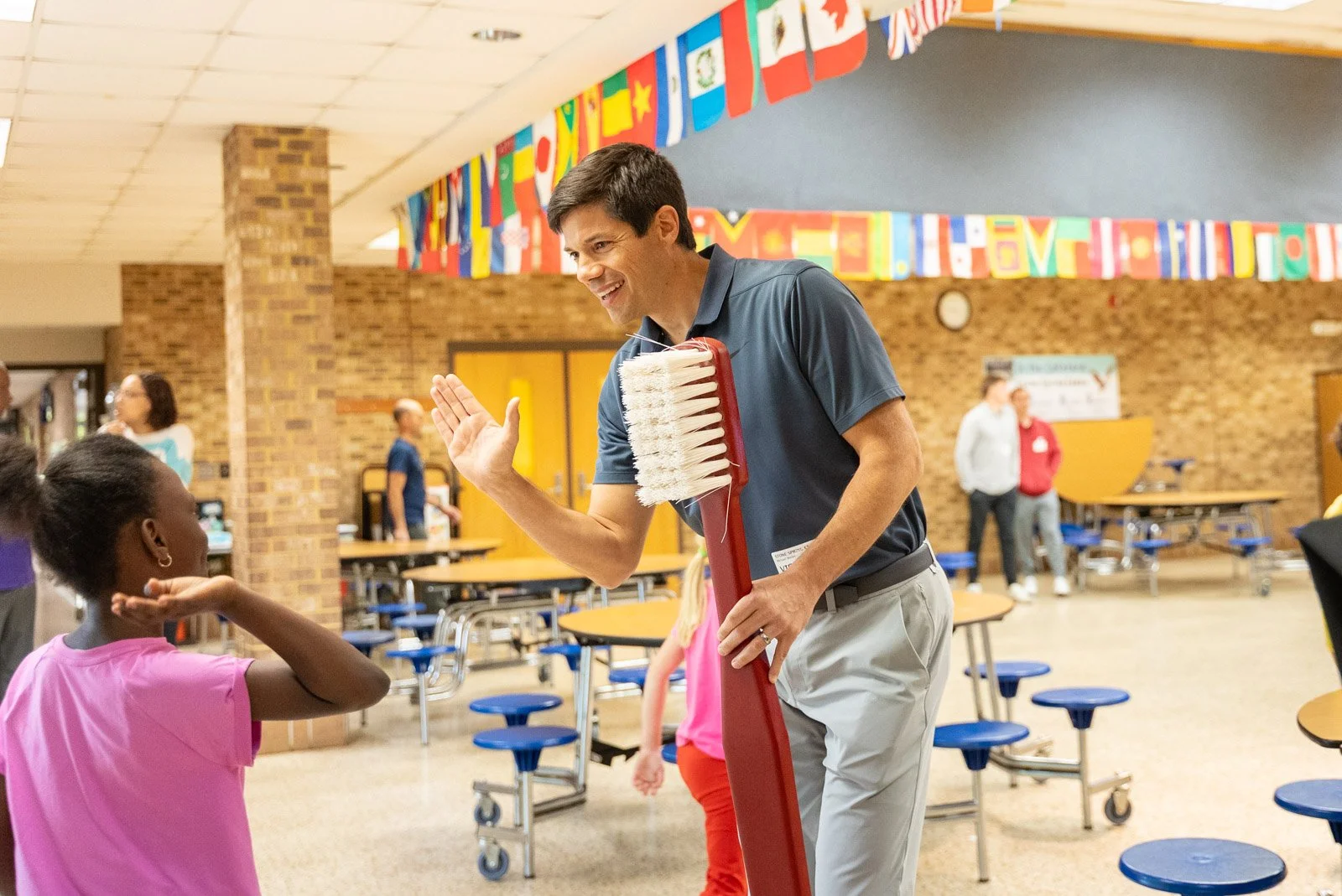 Dr Weiler high fives child at a school visit