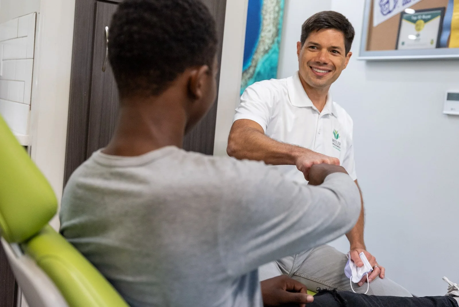 Doctor Weiler smiling and talking with patient