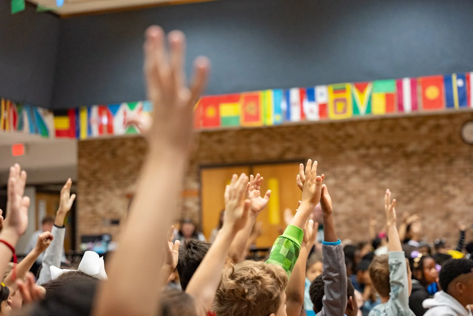 Students raise their hands during the school day, the hours when Invisalign teens have to stay disciplined about aligner wear time