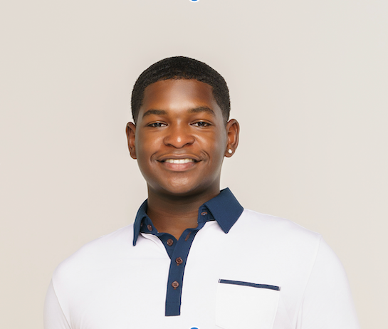 Young man smiling, wearing a white polo shirt with navy collar and accents, against a plain background.