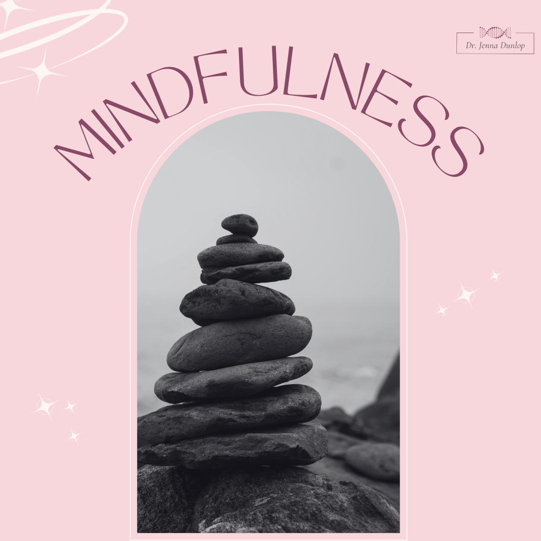 Stacked black stones on a beach with a foggy sky in the background, framed by a pink decorative border with the text 'Mindfulness' and a small label 'Dr. Jenna Dunlop'.