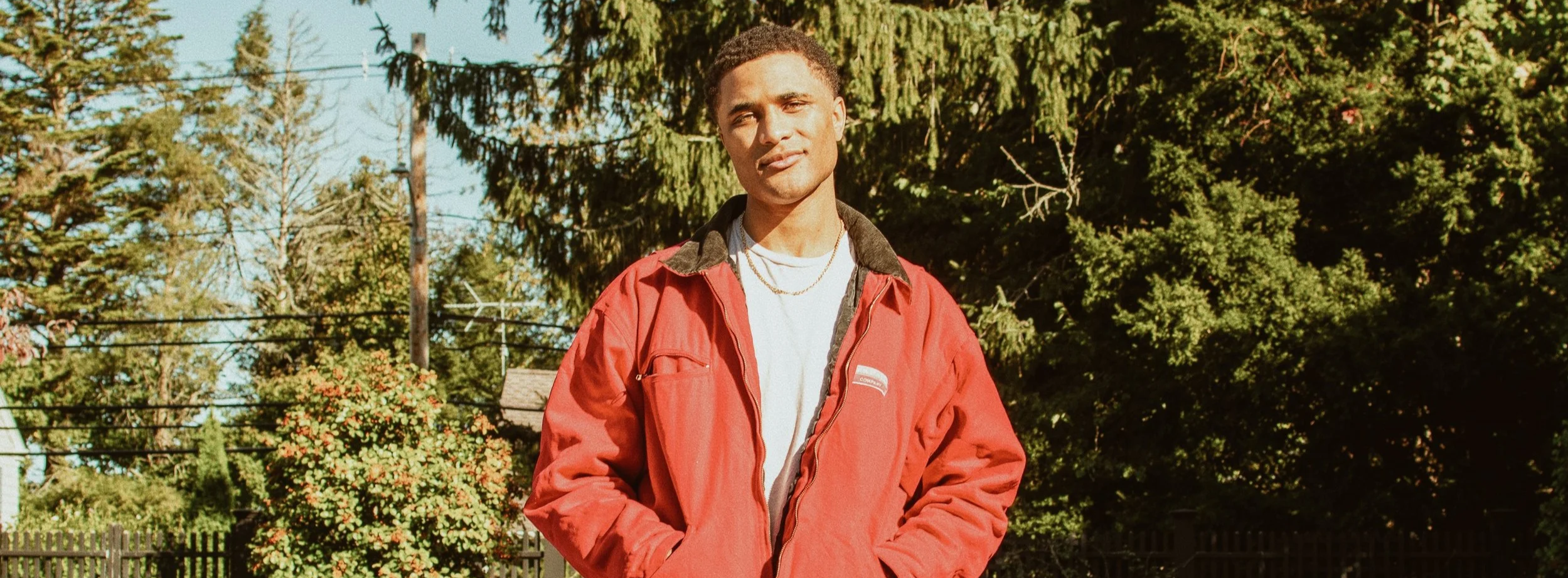 SE4NKENNEDY, independent artist and founder of LO$T ONE$ Records, standing outdoors in natural light.