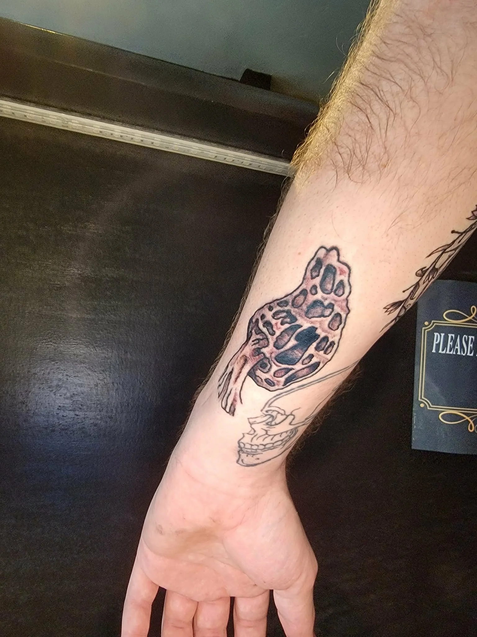 a rework of a tattoo of a morel mushroom on an arm