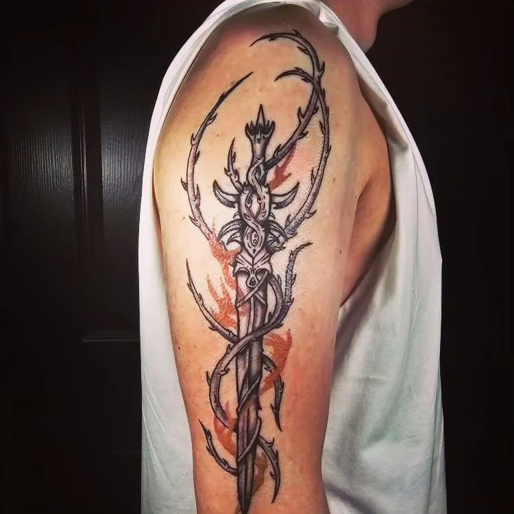 thorny sword on upper arm in black an grey style