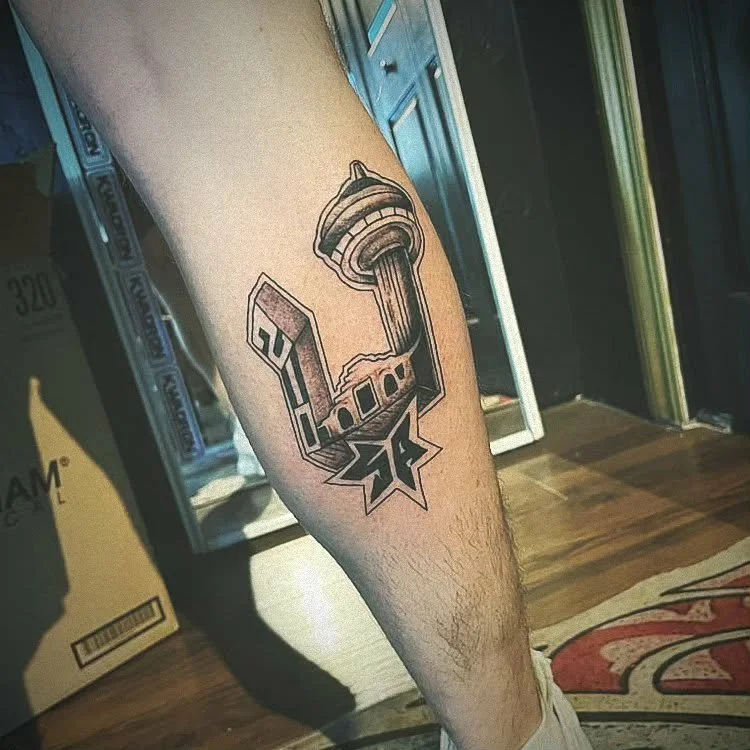 Tattoo of Seattle Space Needle and a baseball bat on a person's calf.