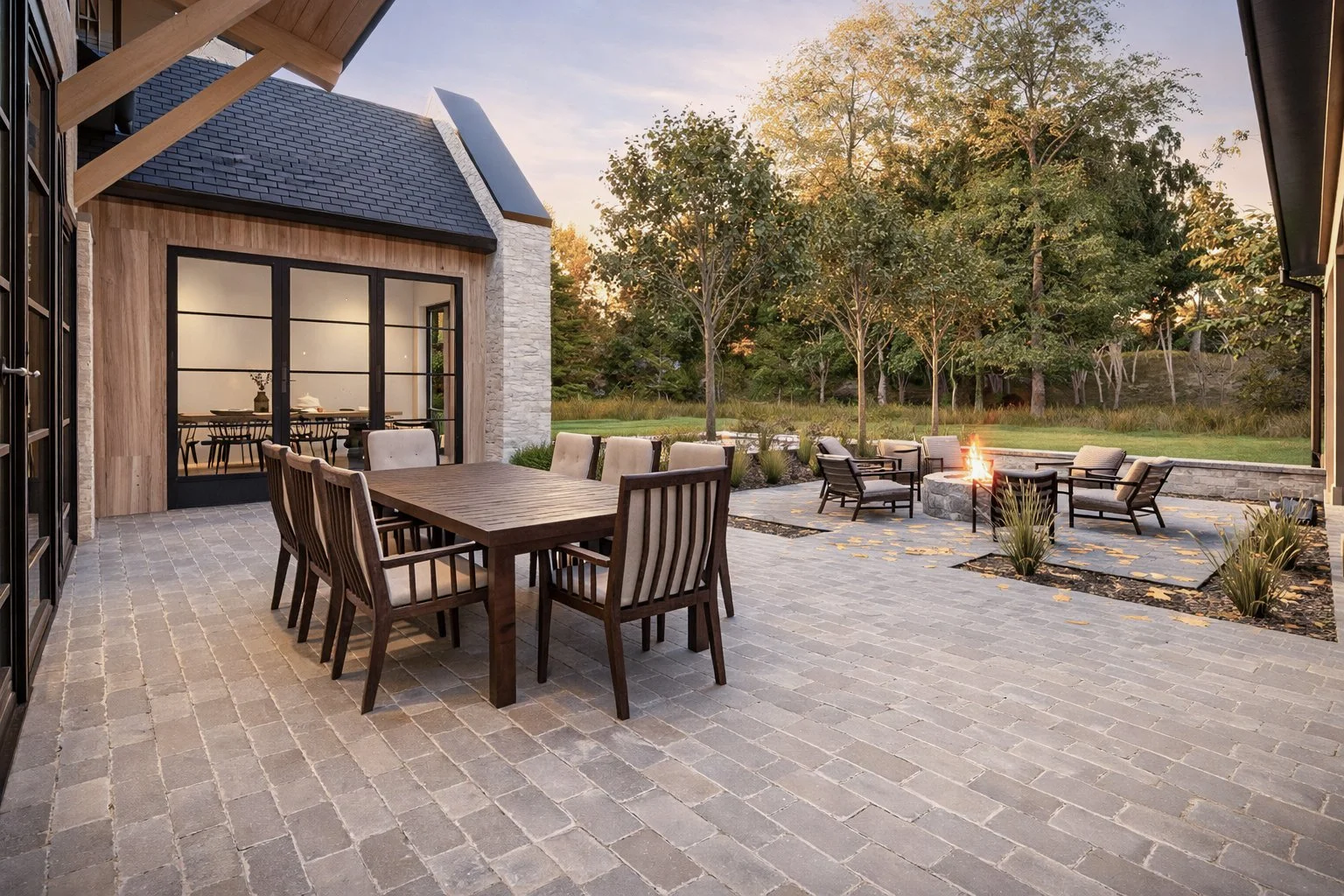 Covered veranda with prominent pillars and a large wooden table set for luxury al fresco outdoor dining.