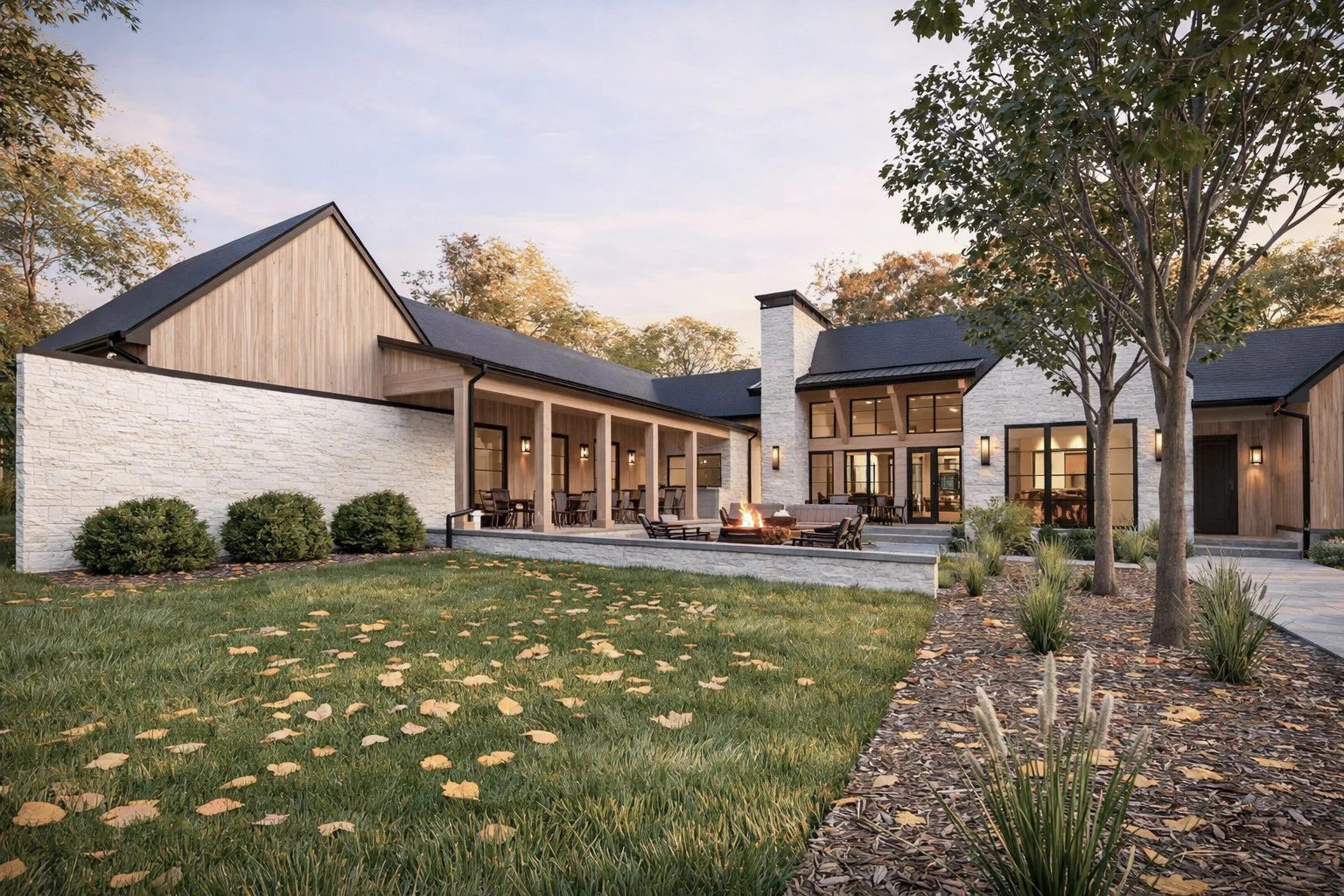 Towering outdoor stone fireplace and chimney stack integrated into a luxury home's back facade by the pool.