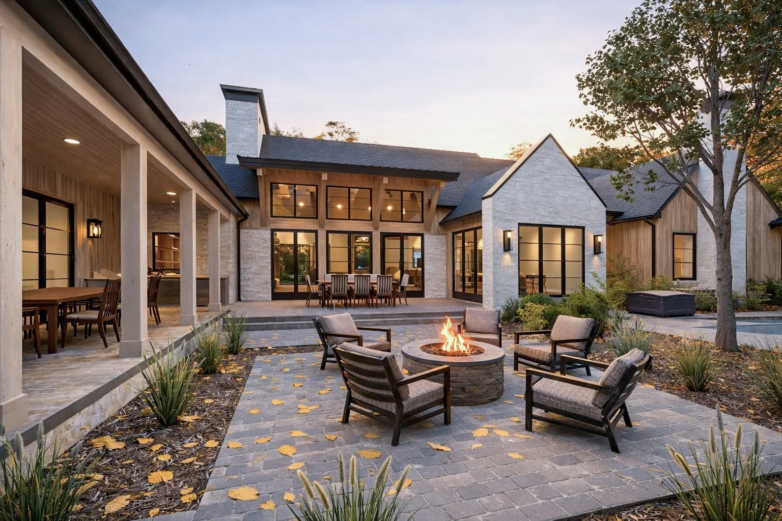 luxury outdoor living featuring a custom swimming pool, a stone patio, and a outdoor firepit