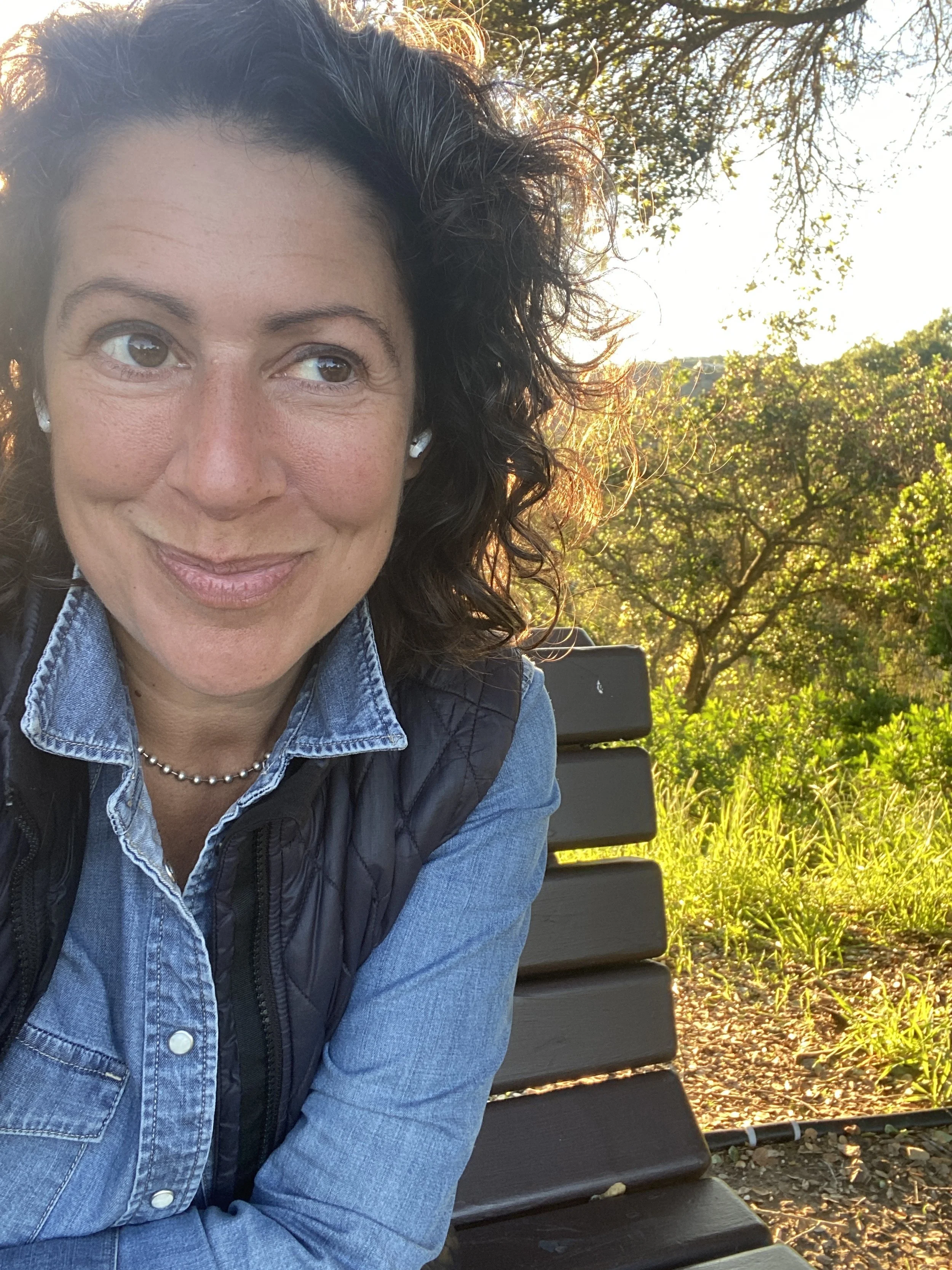Portrait of Amy Lee at sunset surrounded by trees at a park.