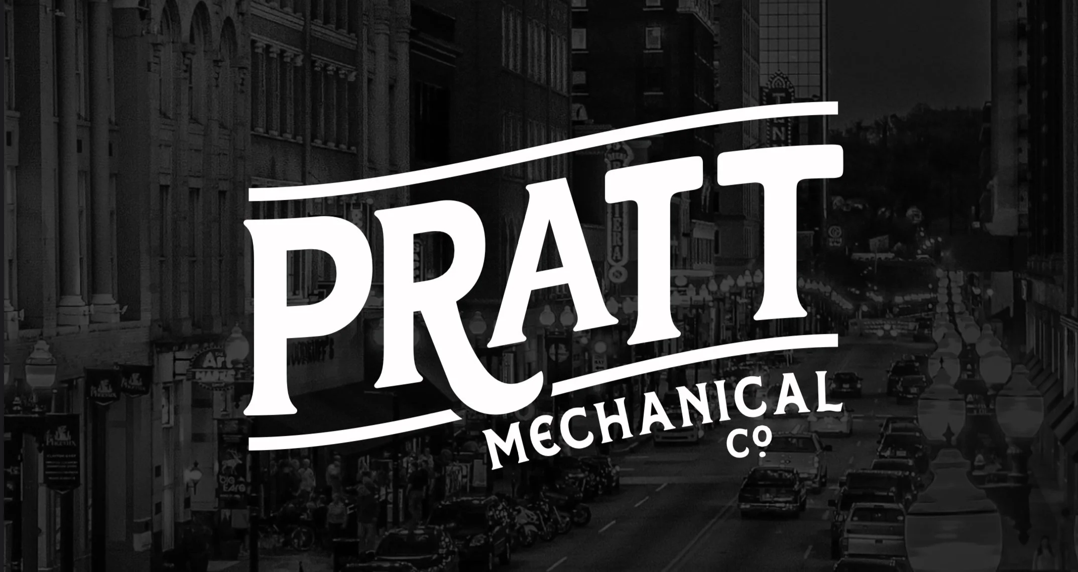 Black and white city street with cars and pedestrians, overlaid with the logo of 'Pratt Mechanical Co.'