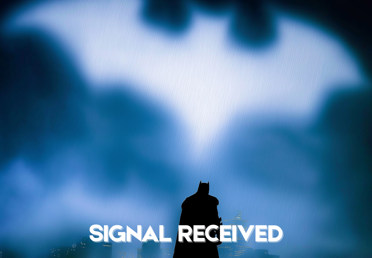 Silhouette of Batman sitting on a building rooftop at night with a city skyline in the background and a large blue light in the sky. The words 'SIGNAL RECEIVED' are overlaid at the bottom of the image.