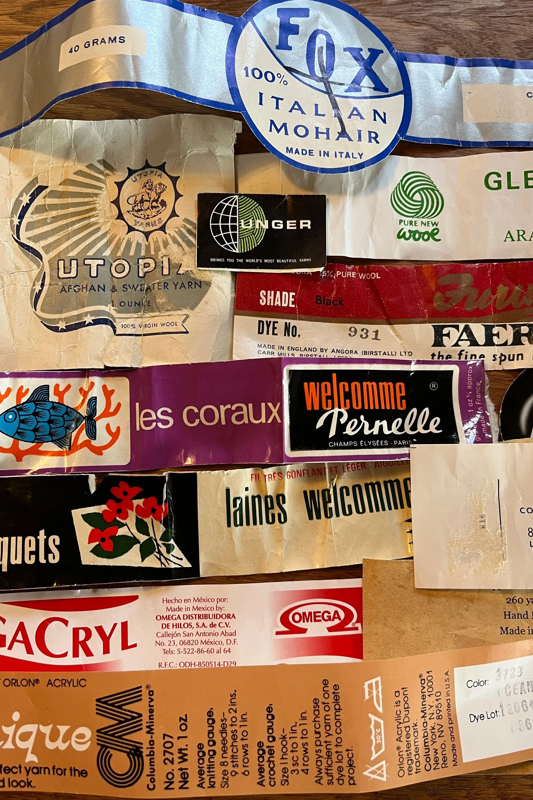 A collection of various yarn labels and packaging, including brands like FOX Italian Mohair, UTOPIA Afghan & Sweater Yarn, Unler, WG Pure New Wool, and others.