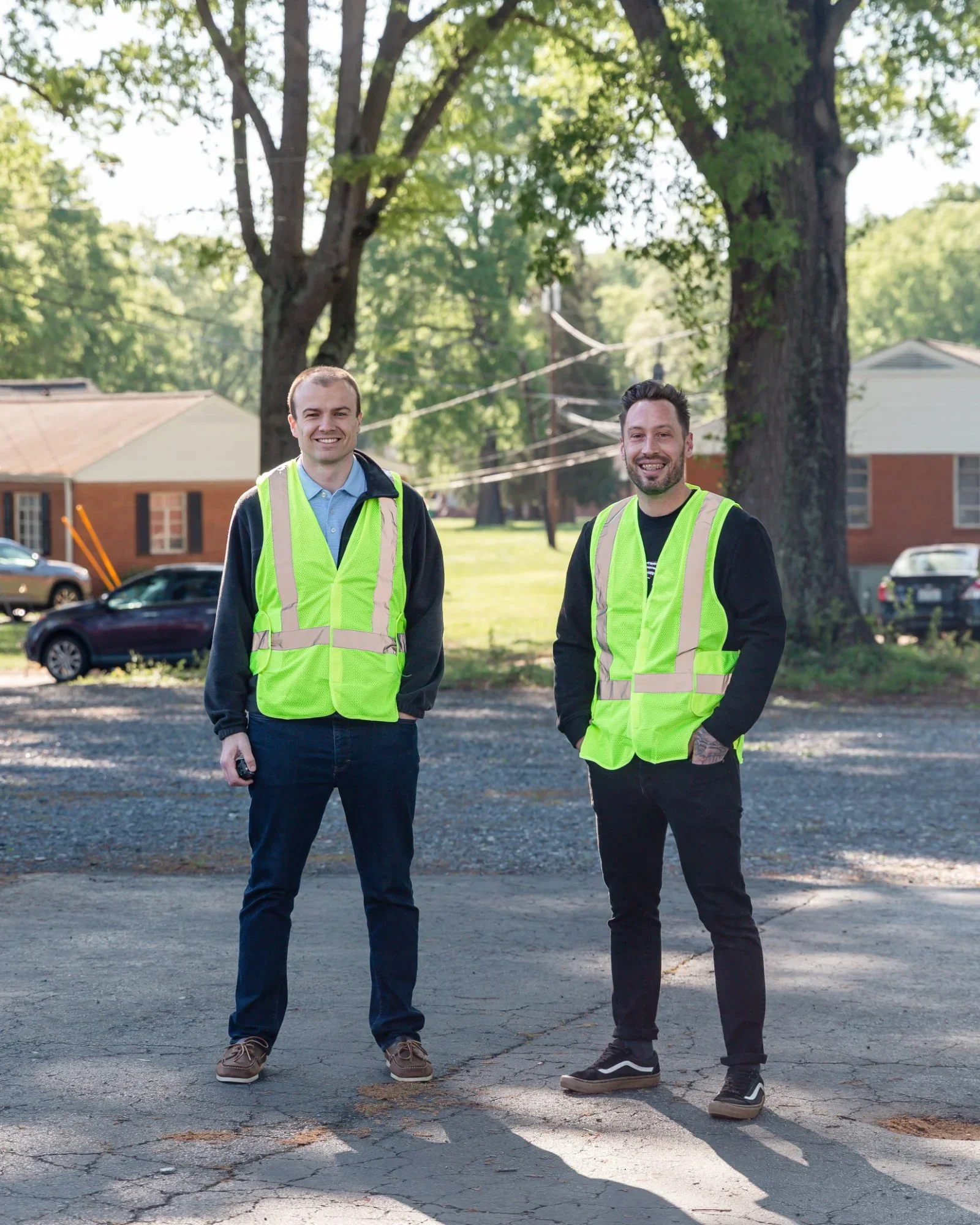 two men in neon vests in church parking lot