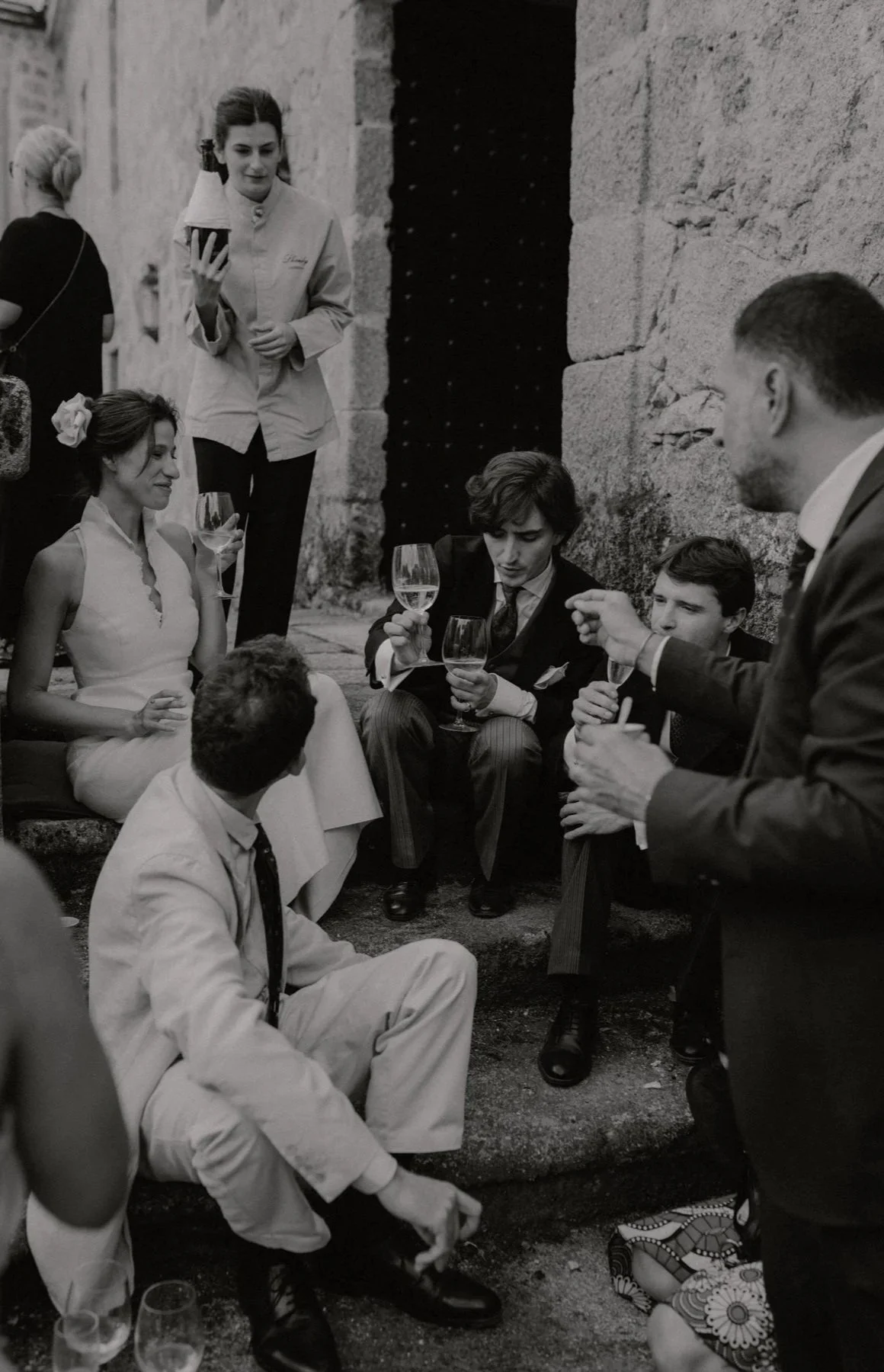 Mix of documentary and editorial style of bride having an unscripted moment with friends in a destination wedding in Spain, photographed by lookimaginary