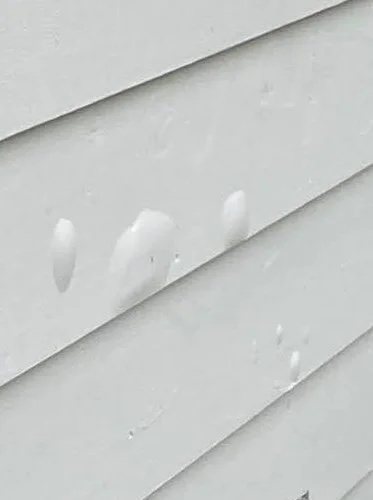 Bubbles forming in siding paint