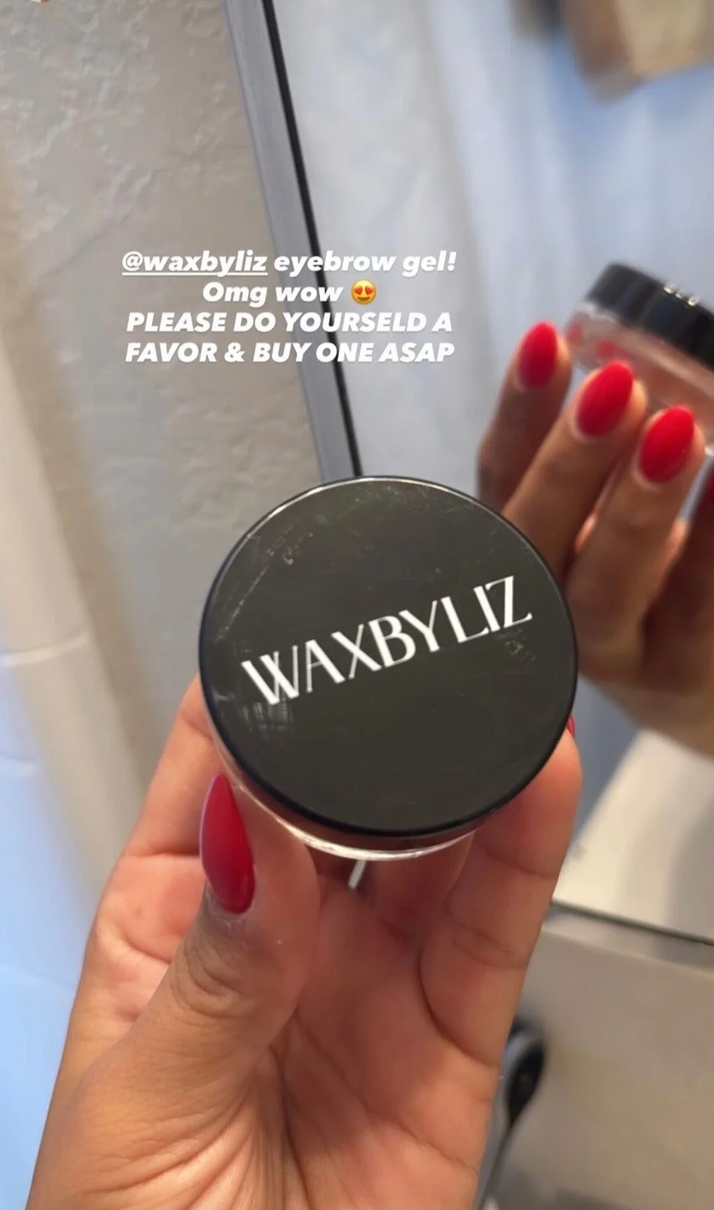 Happy customer holding a container of WAXBYLIZ eyebrow gel, the best product on the market for eyebrows.