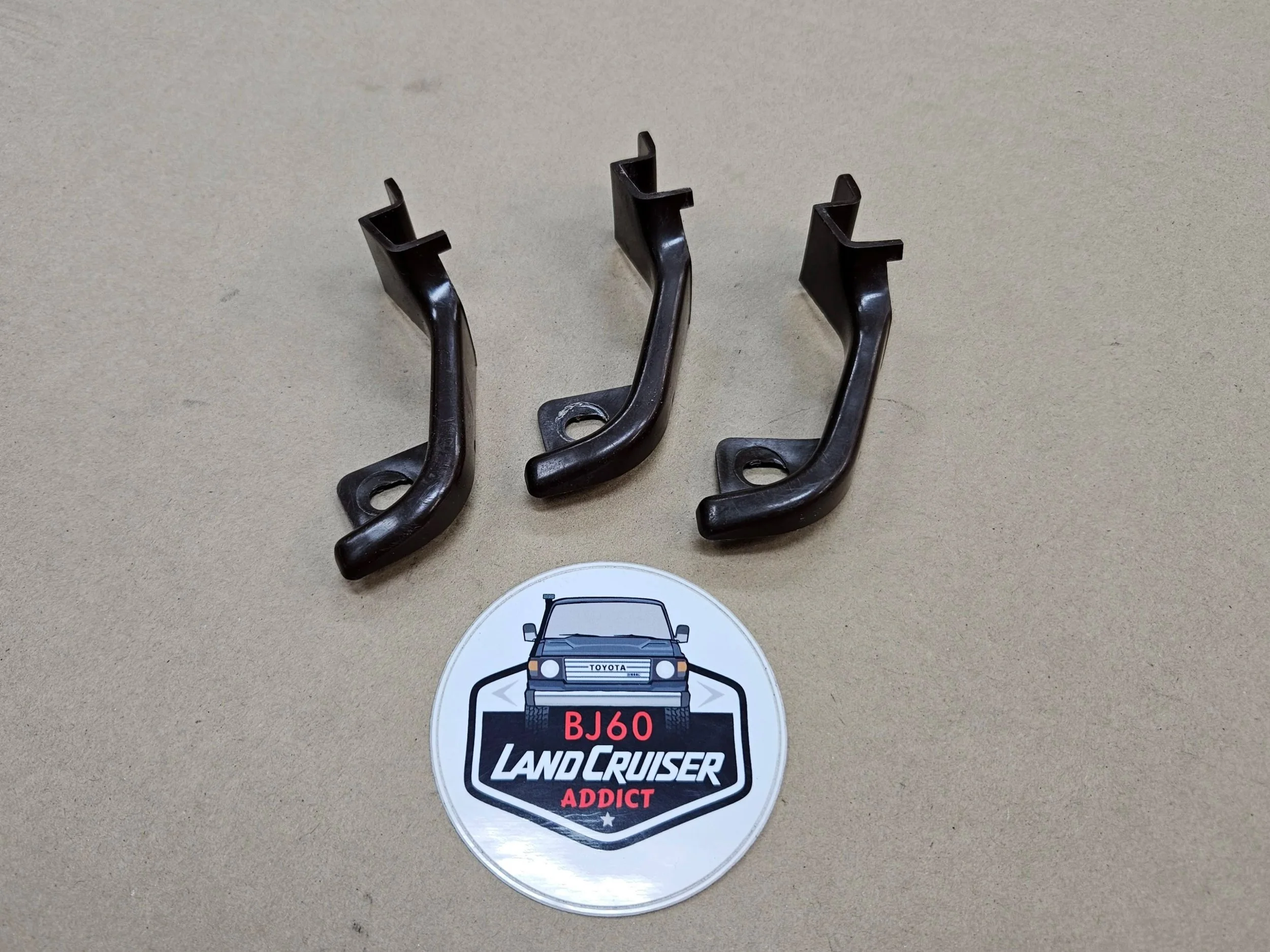 60-series Toyota Landcruiser dark brown left side kick panel cover bracket.