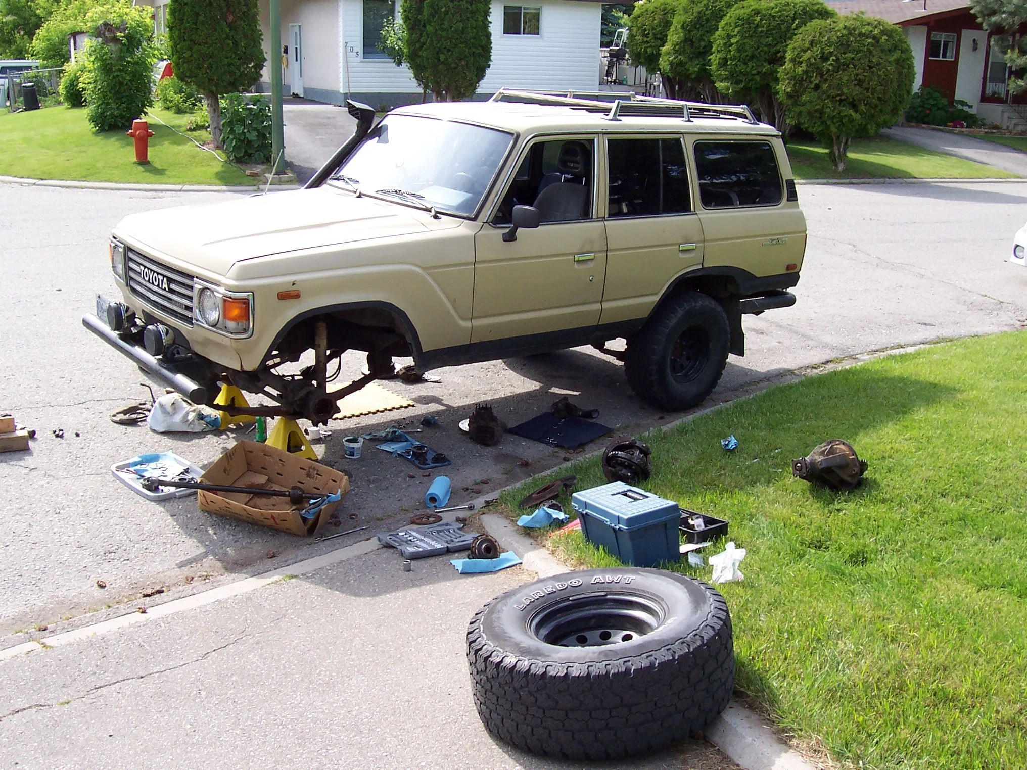 BJ60 Landcruiser undergoing a front differential swap out on the street.