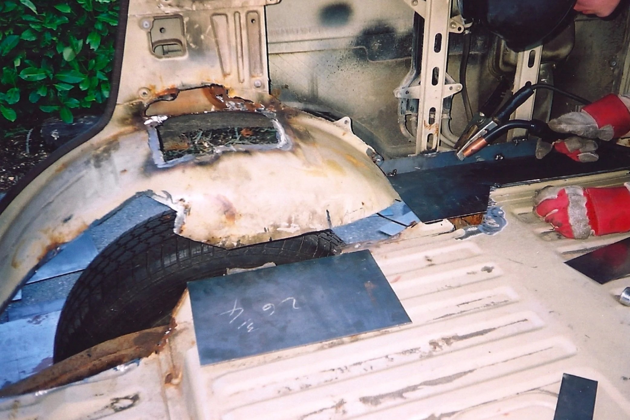 1981 BJ60 with sections of the passenger side wheel-well and floor cut out due to bad rust.