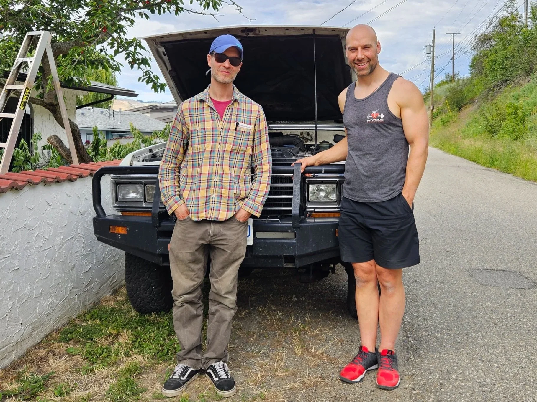 John with a customer in front of an FJ62  Toyota Landcruiser.