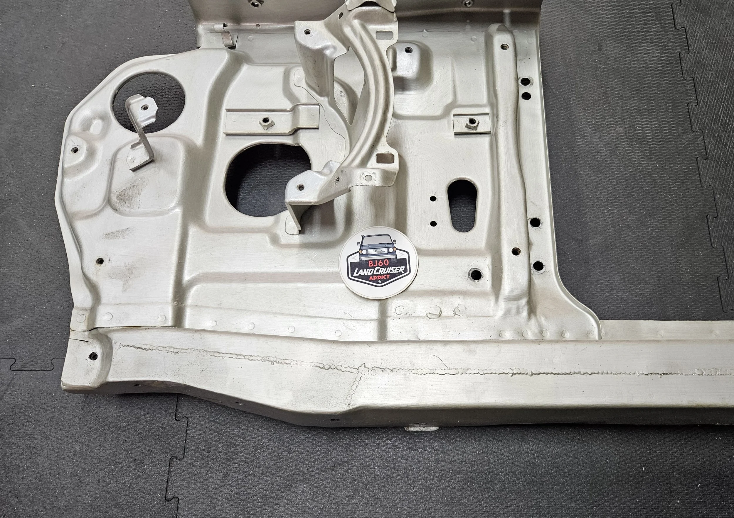 60-series Toyota Landcruiser front core/radiator support, close-up of repair.