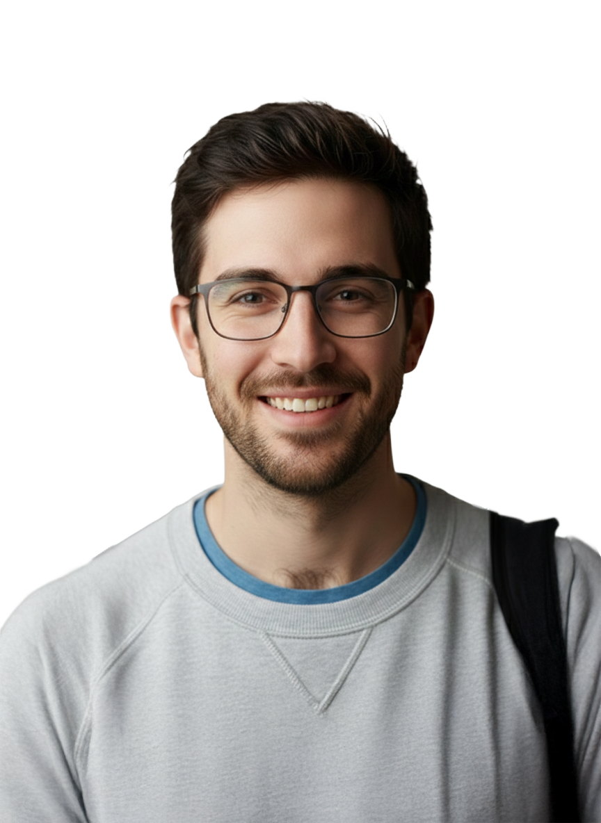 A young man with glasses, smiling, wearing a light gray sweatshirt with a blue collar, and carrying a black backpack.
