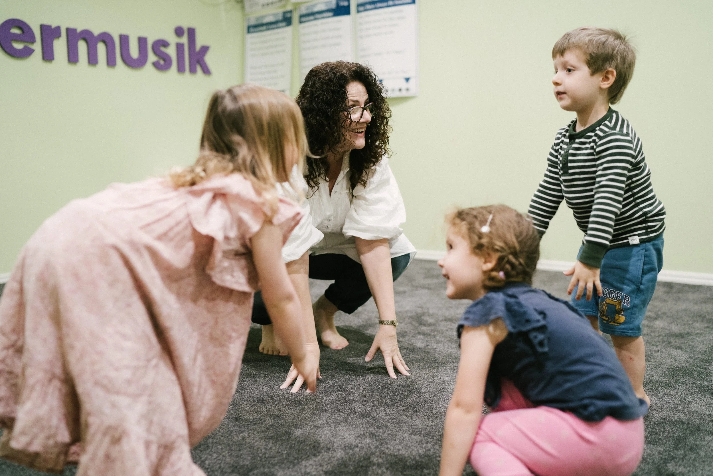 	
Leisa teaching dance and music to young children during a music and movement class.