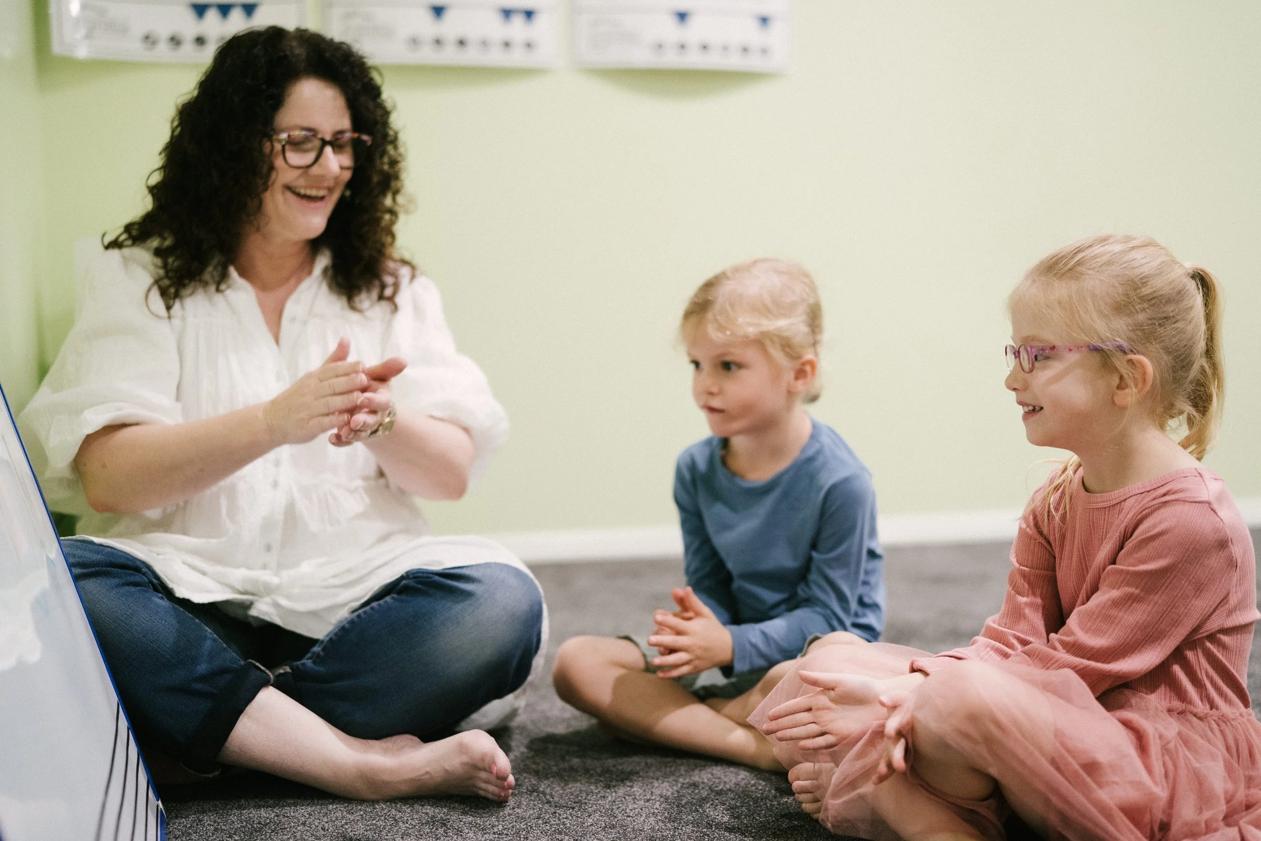 Two young girls learning to read music at a Leisa's Music Place during a Kindermusik class.