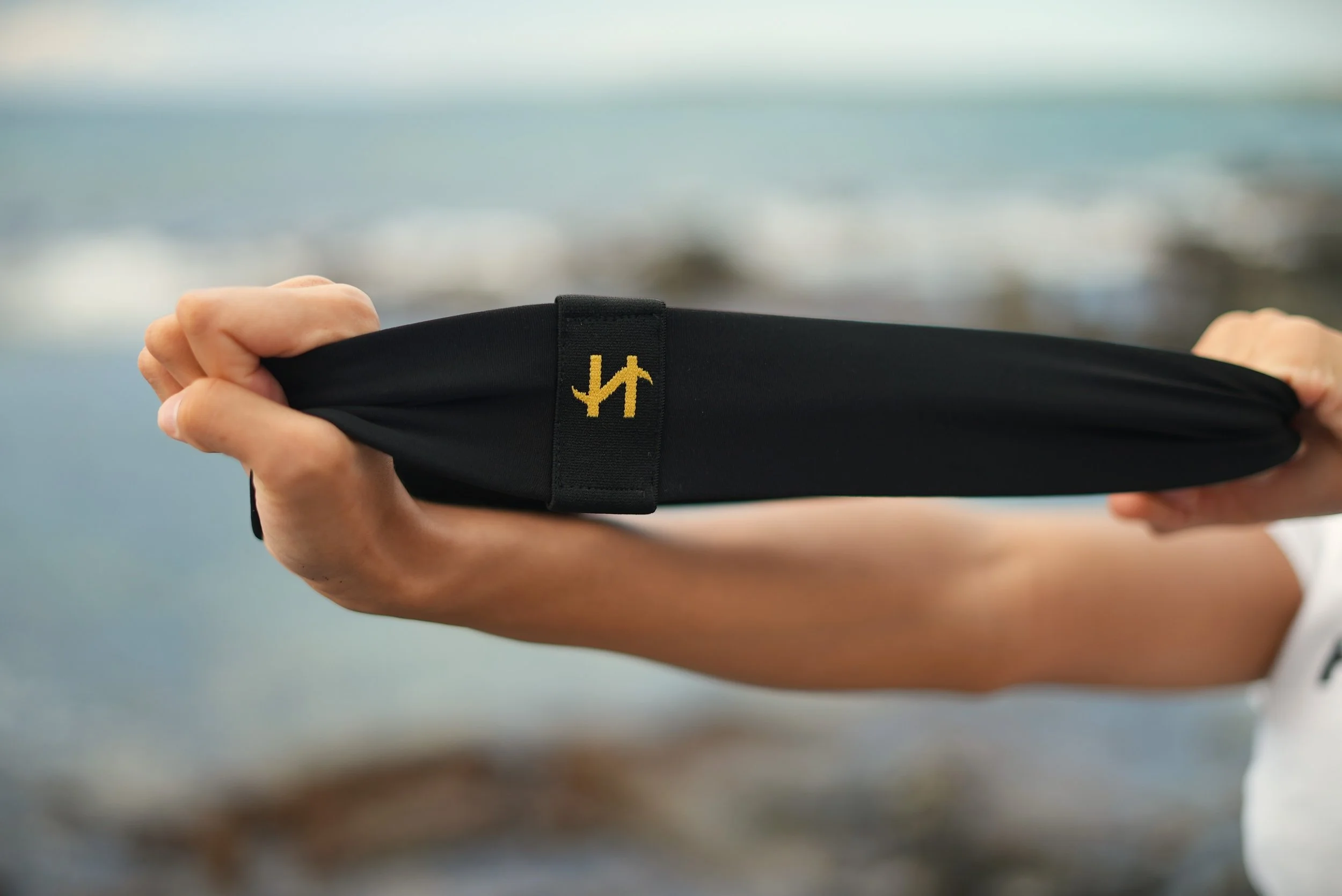 Haut-Ties® wearable resistance headband stretched by hand, showing strength, flexibility and everyday style use