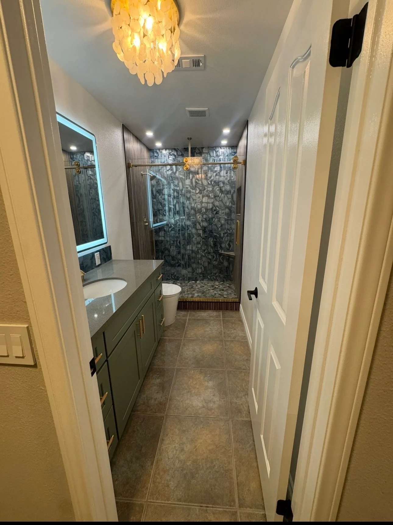 (After photo). Bathroom remodel for project may 30th,  We added a lighted mirror over a quartz top, bathroom vanity cabinet. A Bluetooth smart bidet. We made a custom shower with three gold shower heads, gold shower wand, gold shower head wall mount 