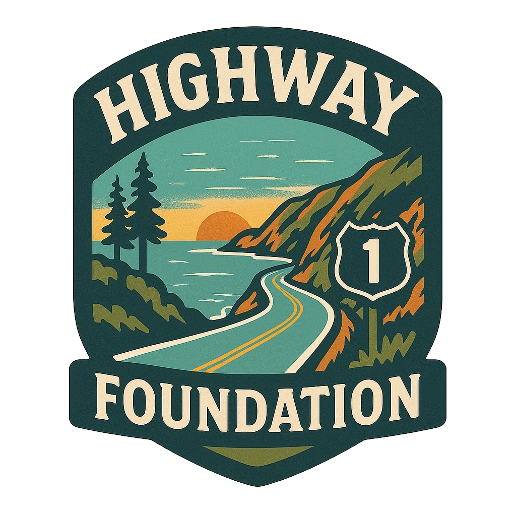 A stylized illustration of a scenic highway near the coast with trees, mountains, a sunset, and a road sign for U.S. Route 1, with the text 'Highway 1 Foundation'.