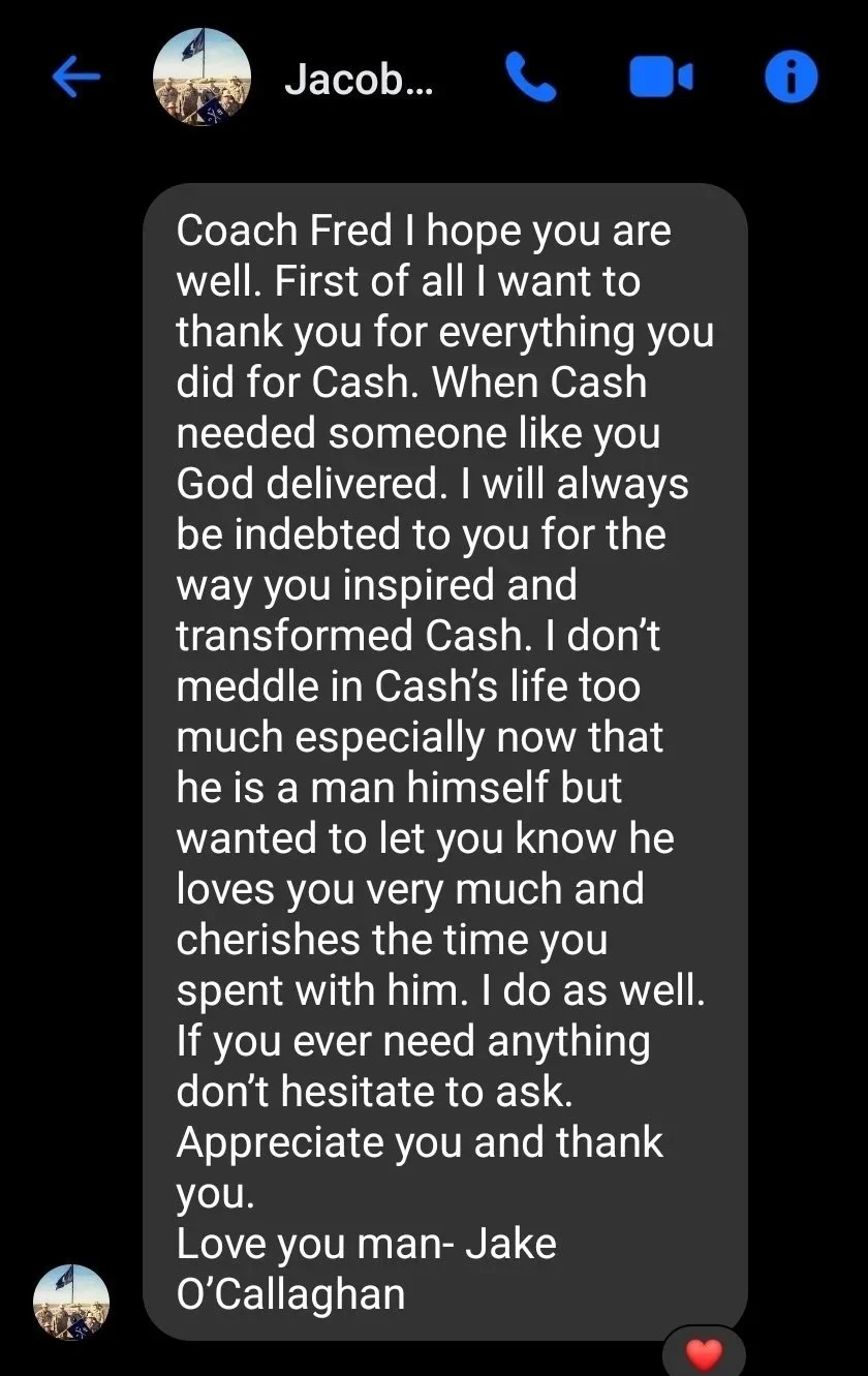 Screenshot of a heartfelt message from Jake O’Callaghan praising Coach Fred, expressing gratitude and love, with a small photo of a person in front of a flag scene at the top and a red heart emoji at the bottom.