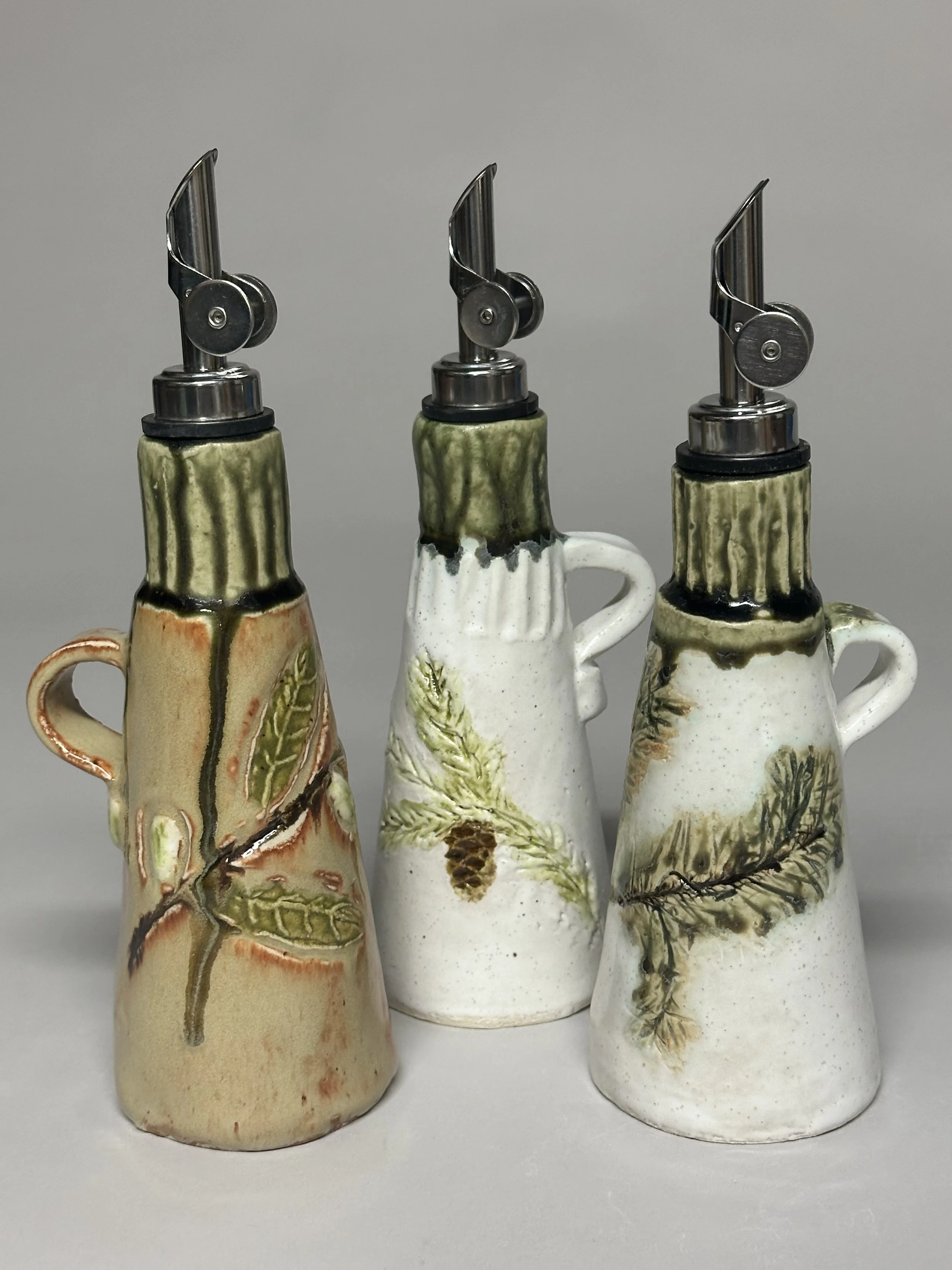 This oil jar is finished with handmade stamps and glazed in Santorini Green, soft oatmeals, and Shino for a clean, earthy look. SOLD!