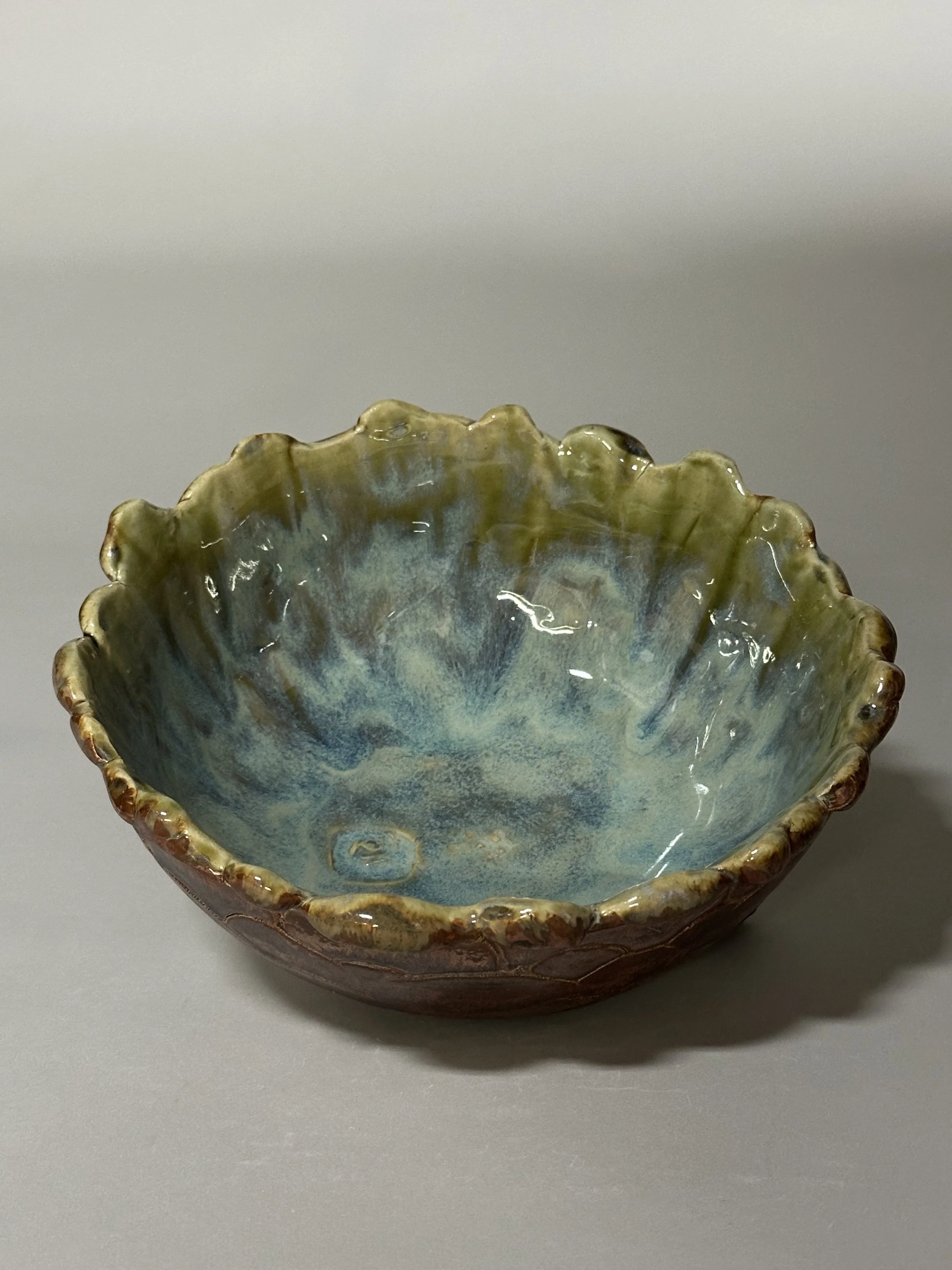 A medium‑size bowl glazed with copper and eight layered glazes, creating depth, movement, and a rich, dimensional finish.